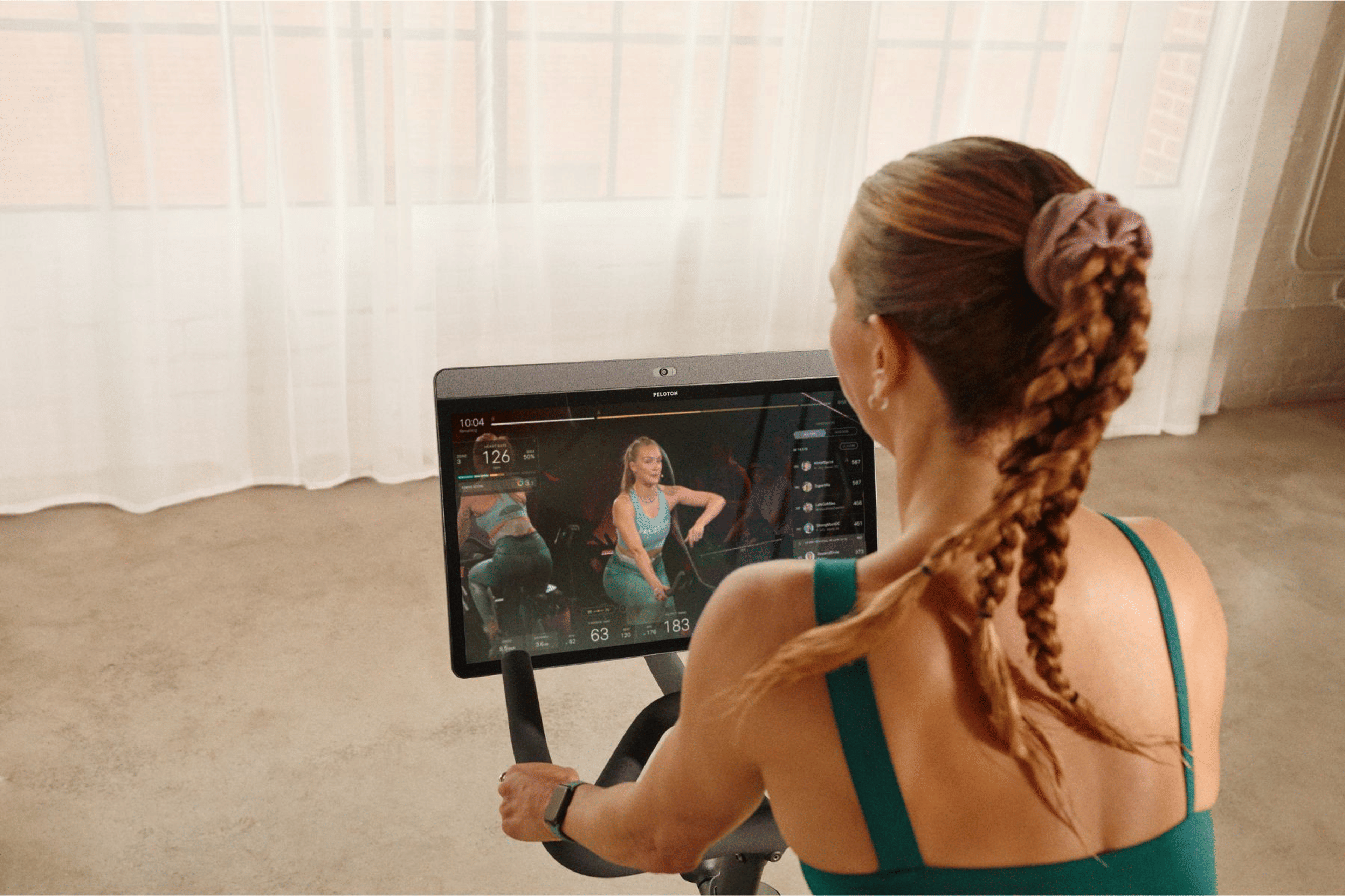 A woman rides on a Peloton Bike
