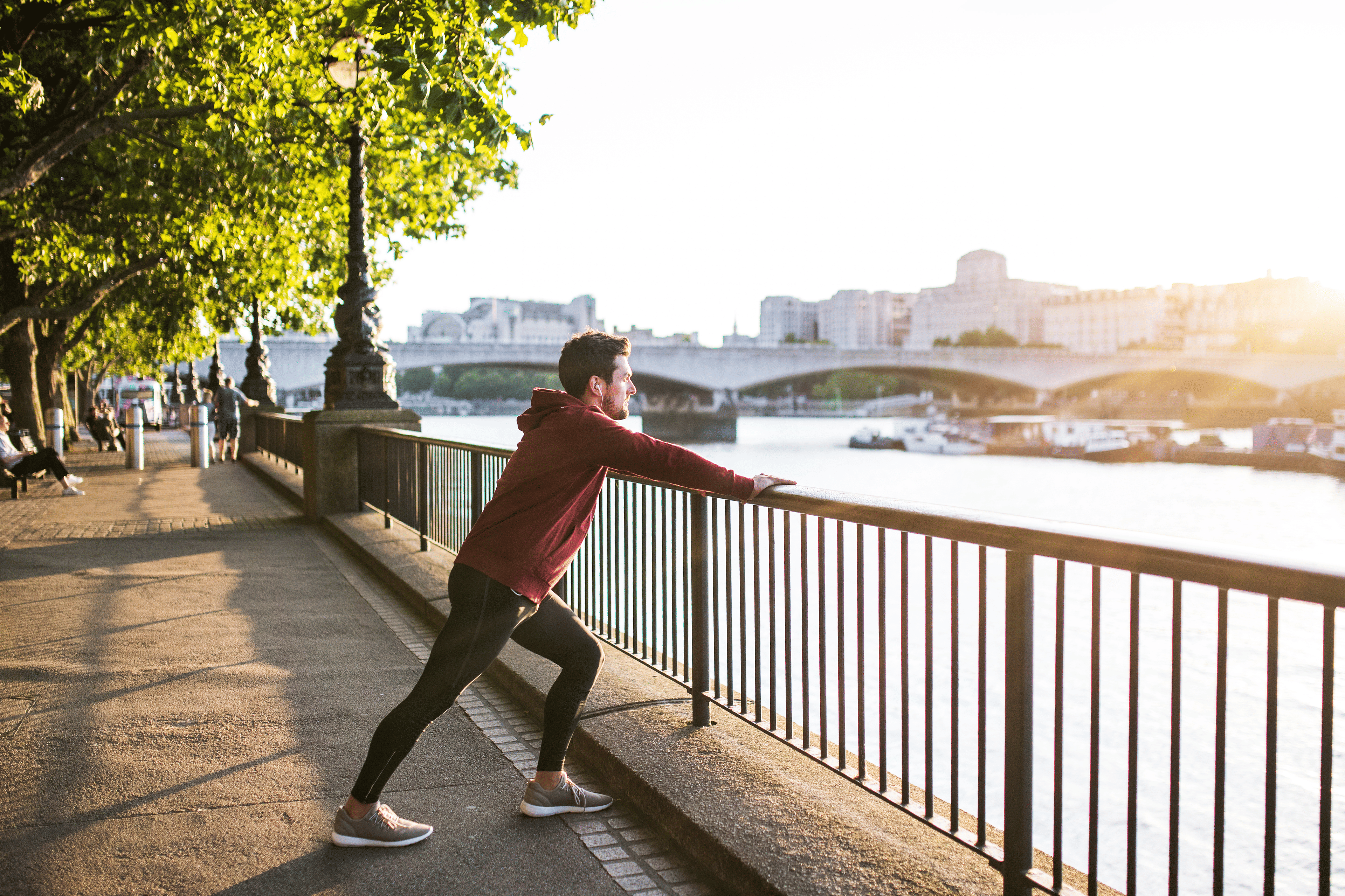 Man does a calf stretch outdoors after a run