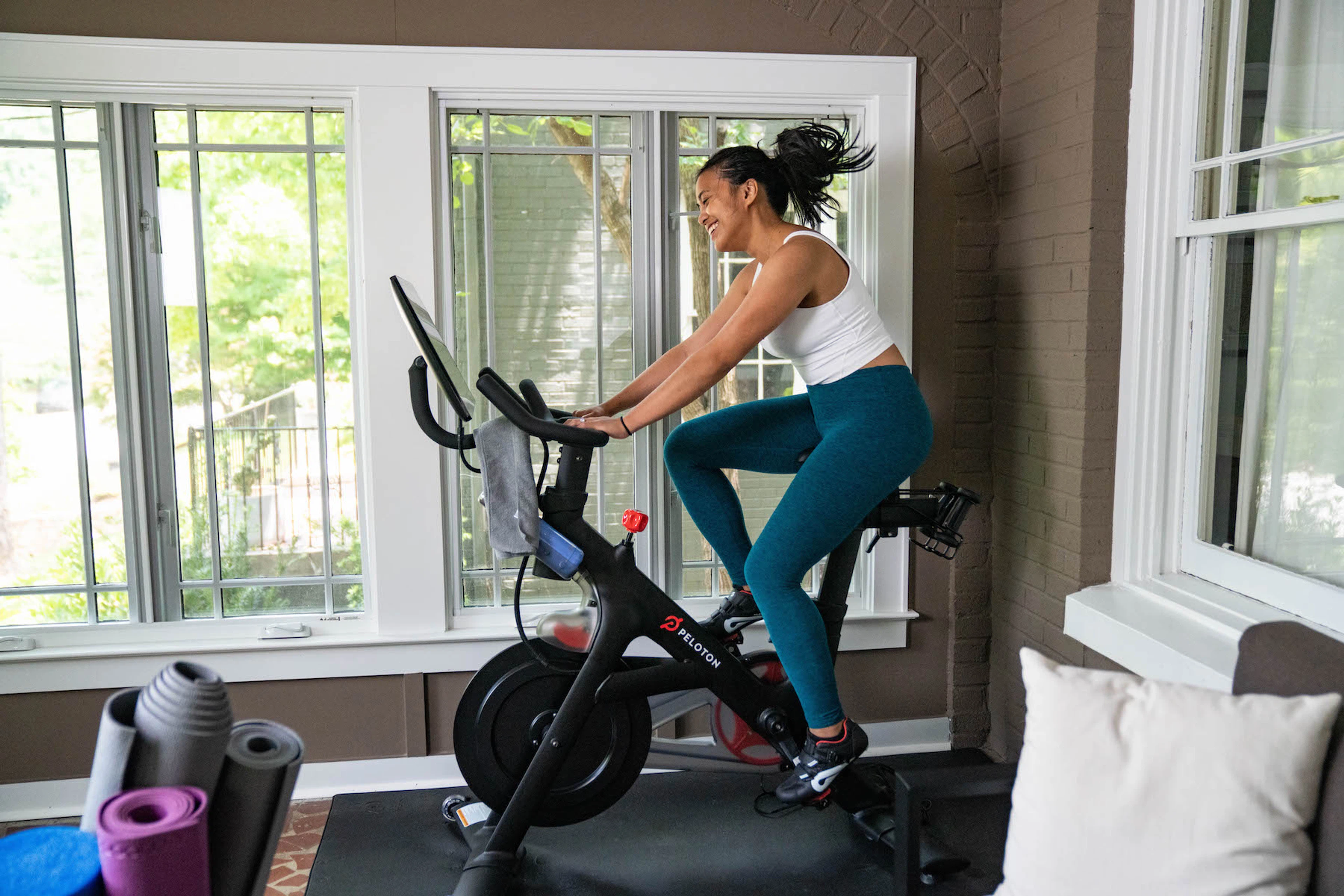 Woman riding on a Peloton Bike