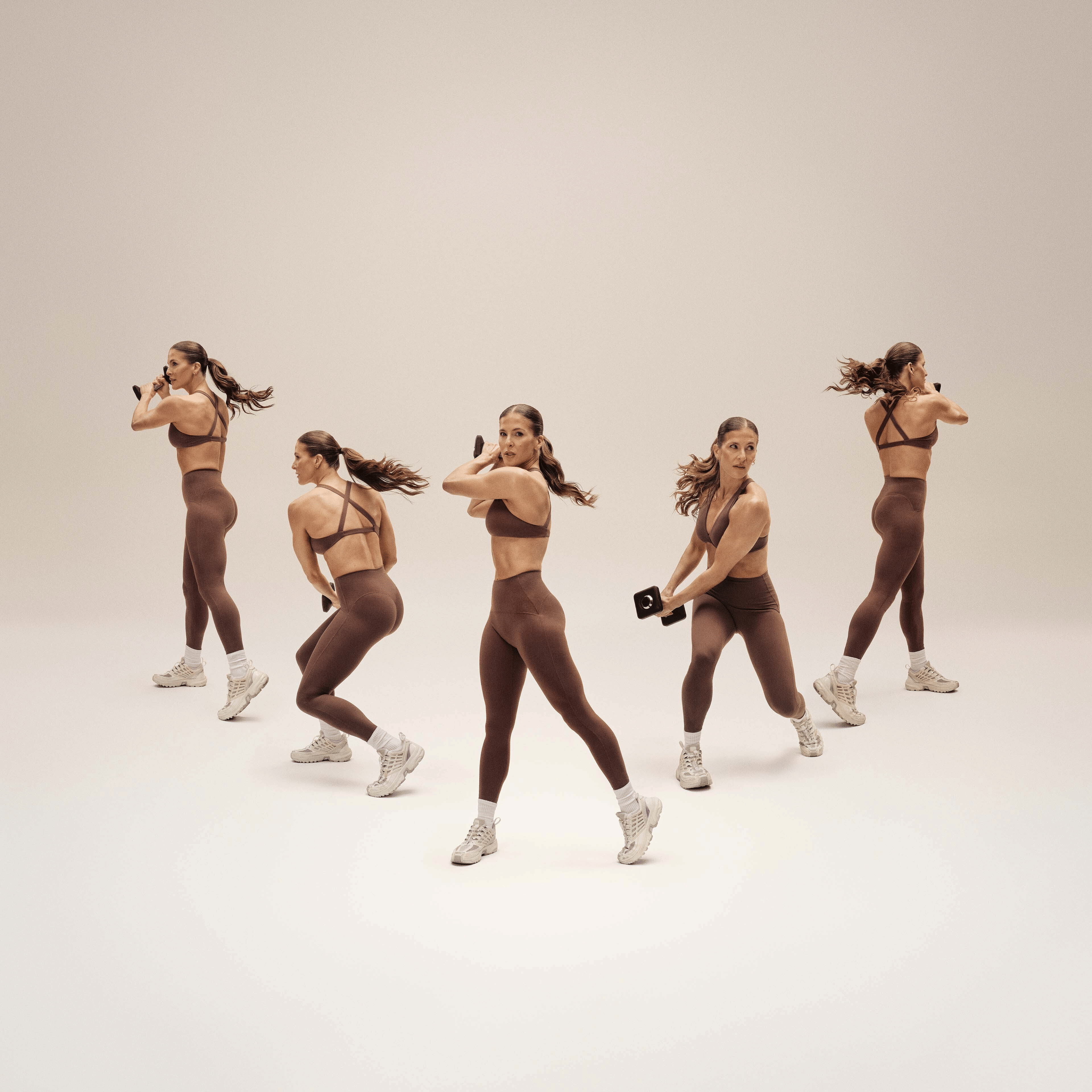 Five sequential images of a woman in brown athletic wear demonstrating a dynamic, twisting dumbbell exercise.