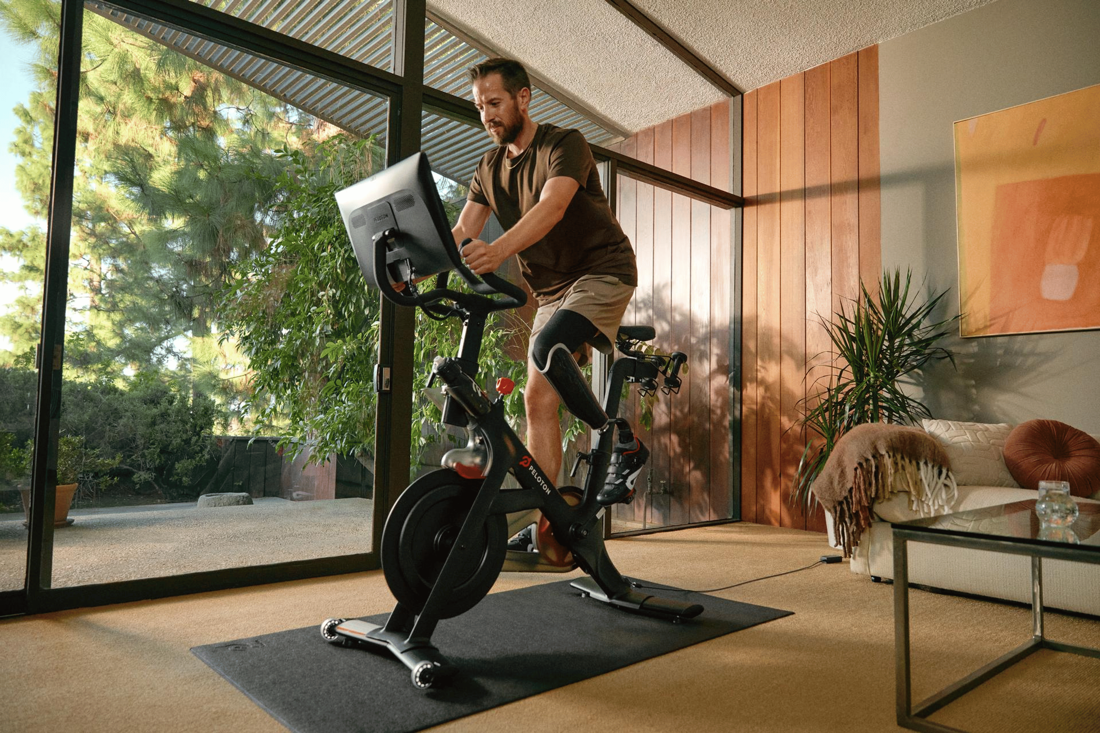 man riding Peloton bike