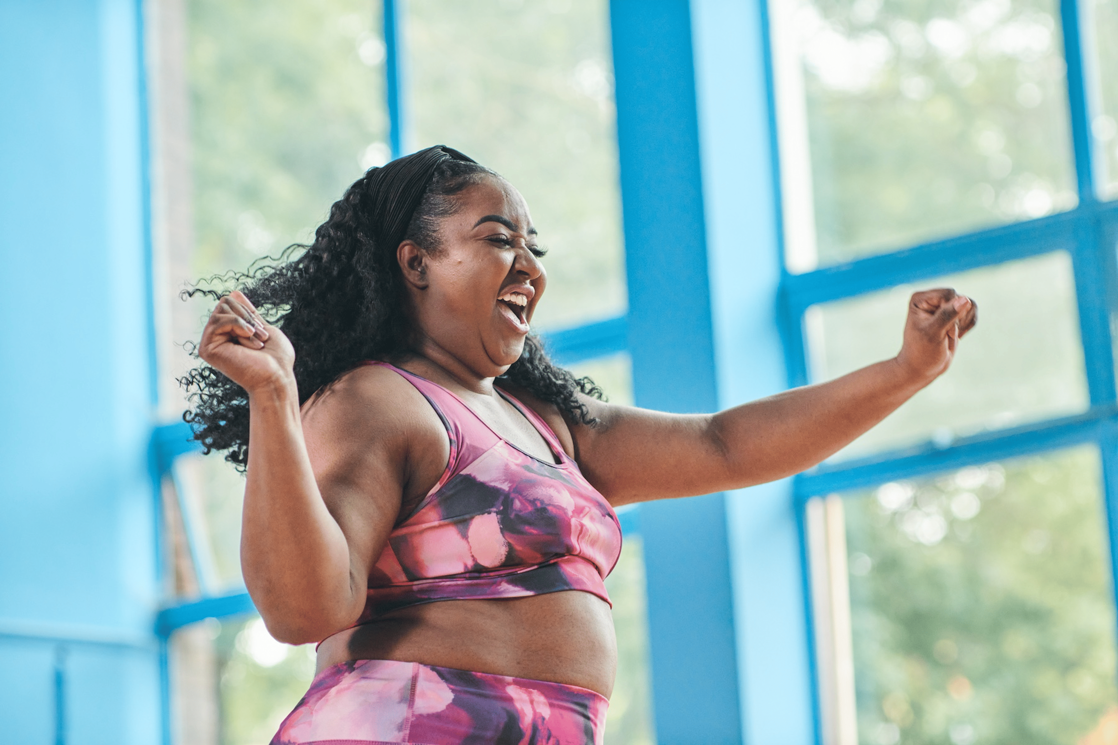 A woman dancing for cardio exercise at home.