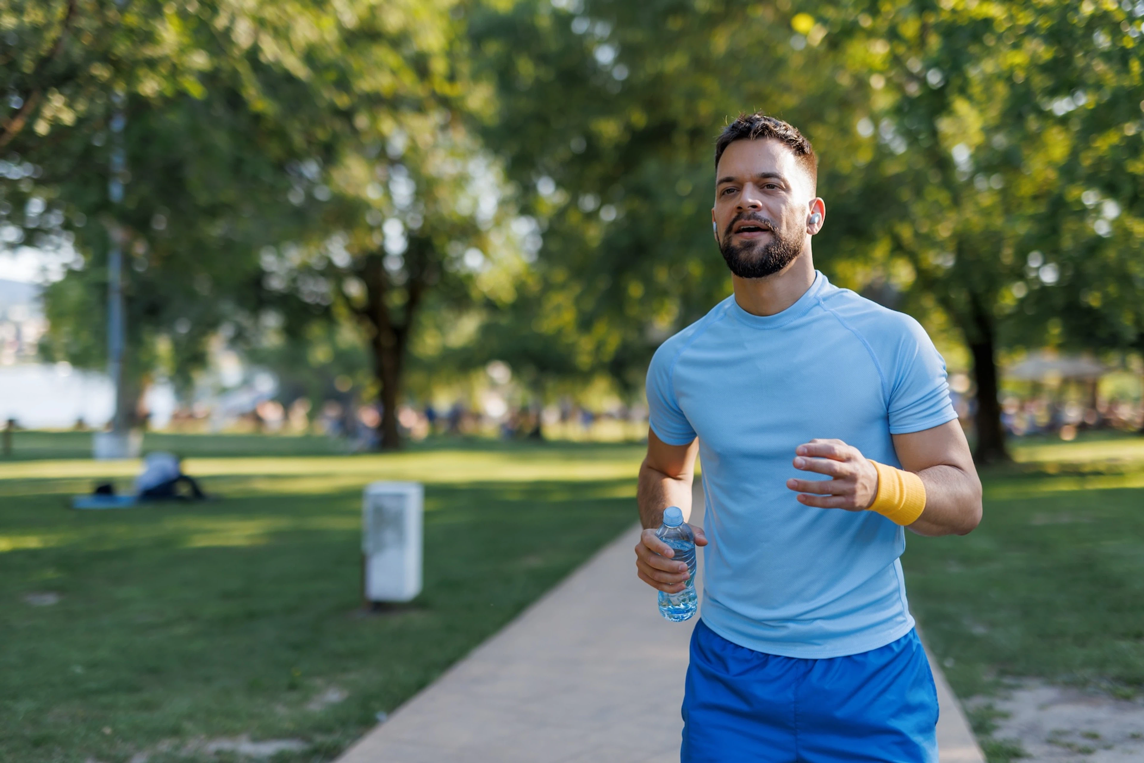 A man going for an outdoor jog in a park.