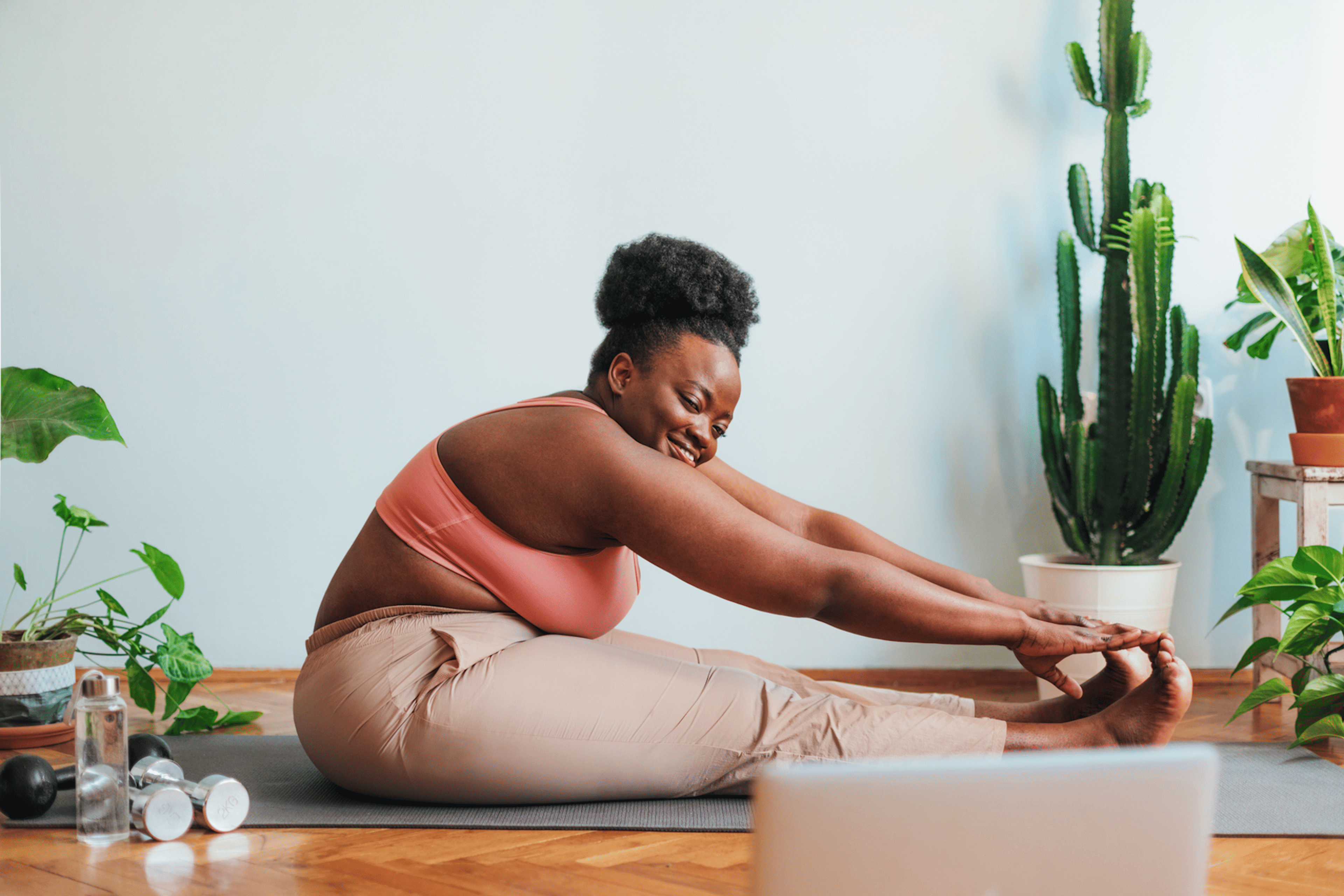Woman does glute stretches on a yoga mat