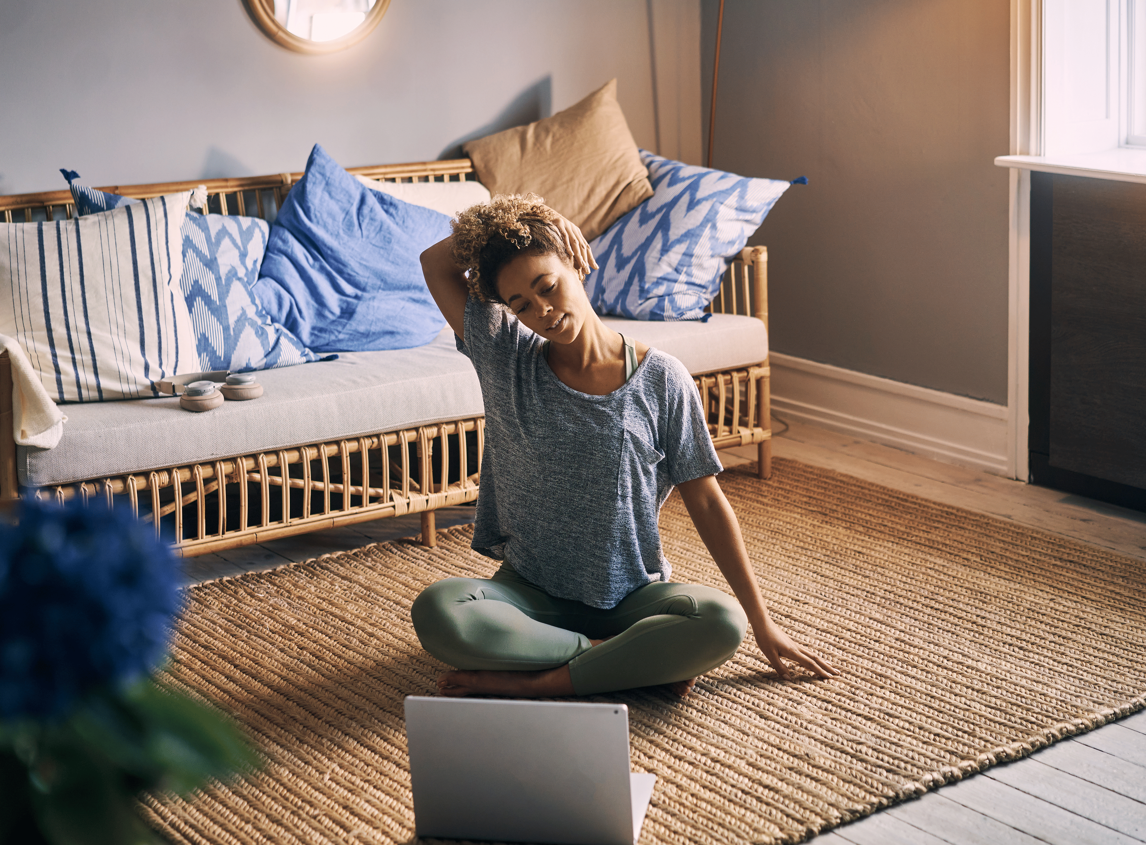 Woman does upper body stretches at home 