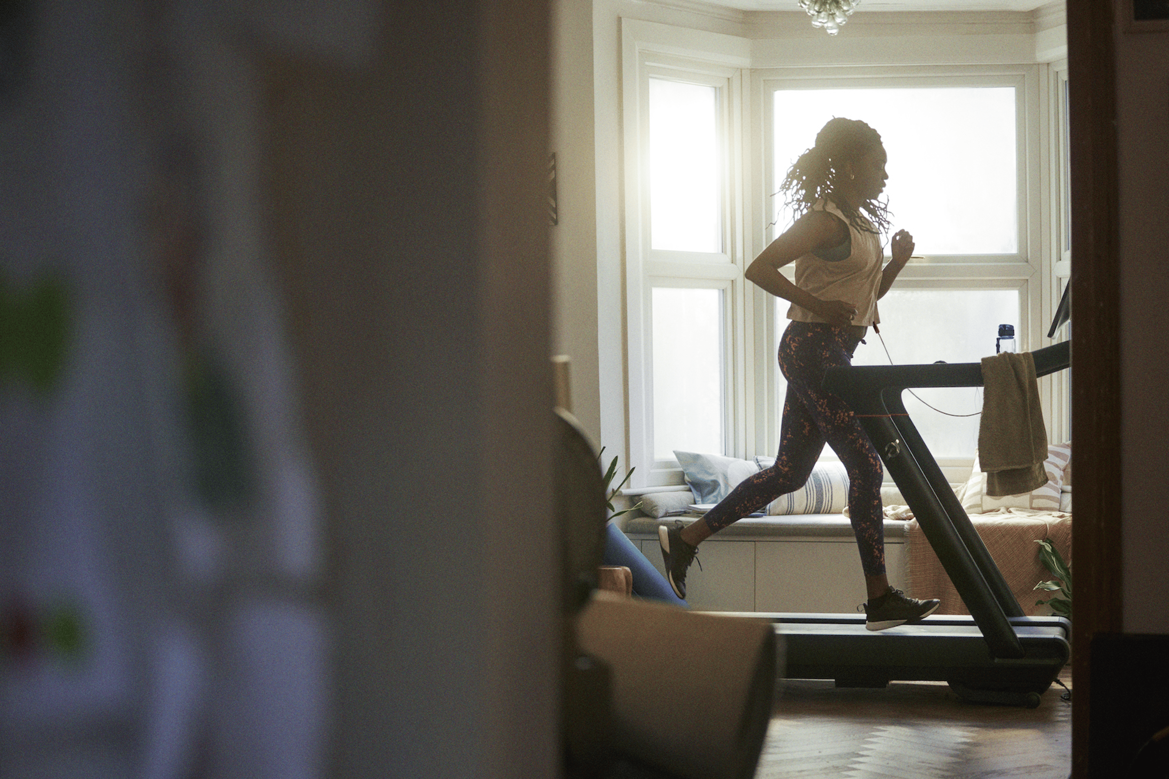 Peloton member running on a Peloton Tread indoors