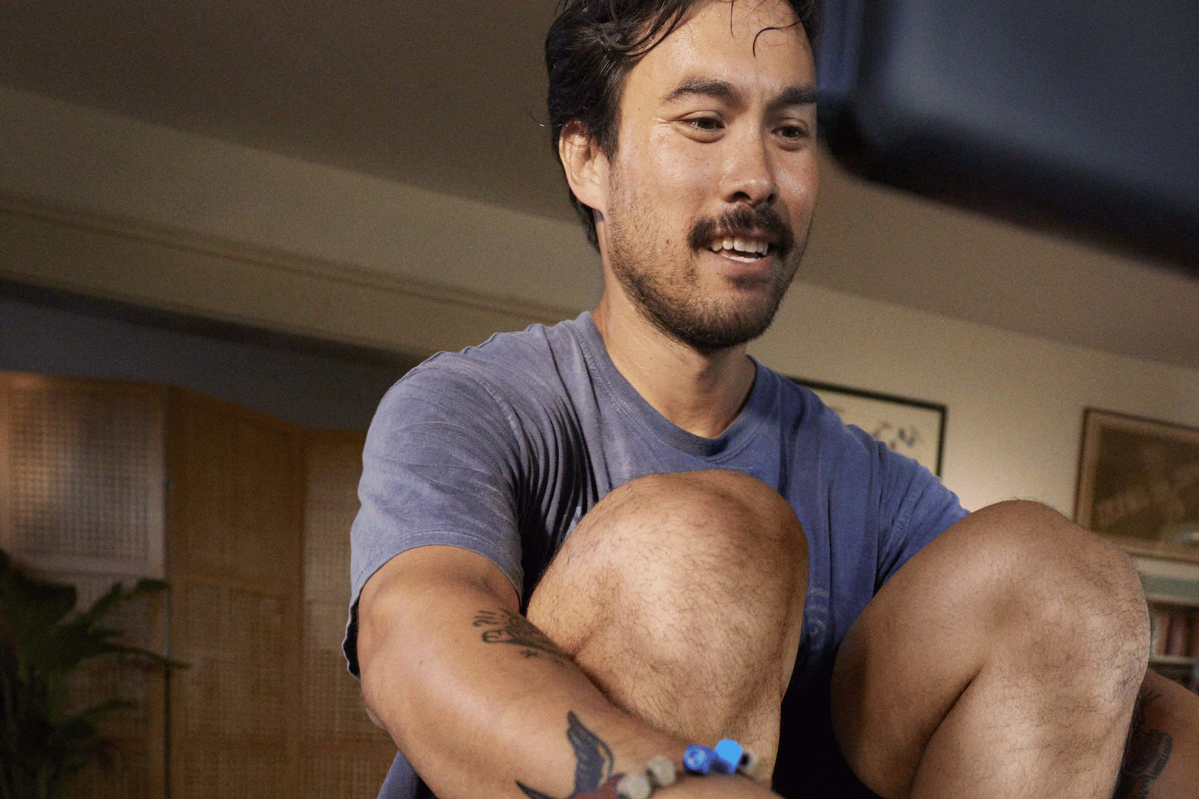 Peloton member on the Peloton row, smiling from motivation