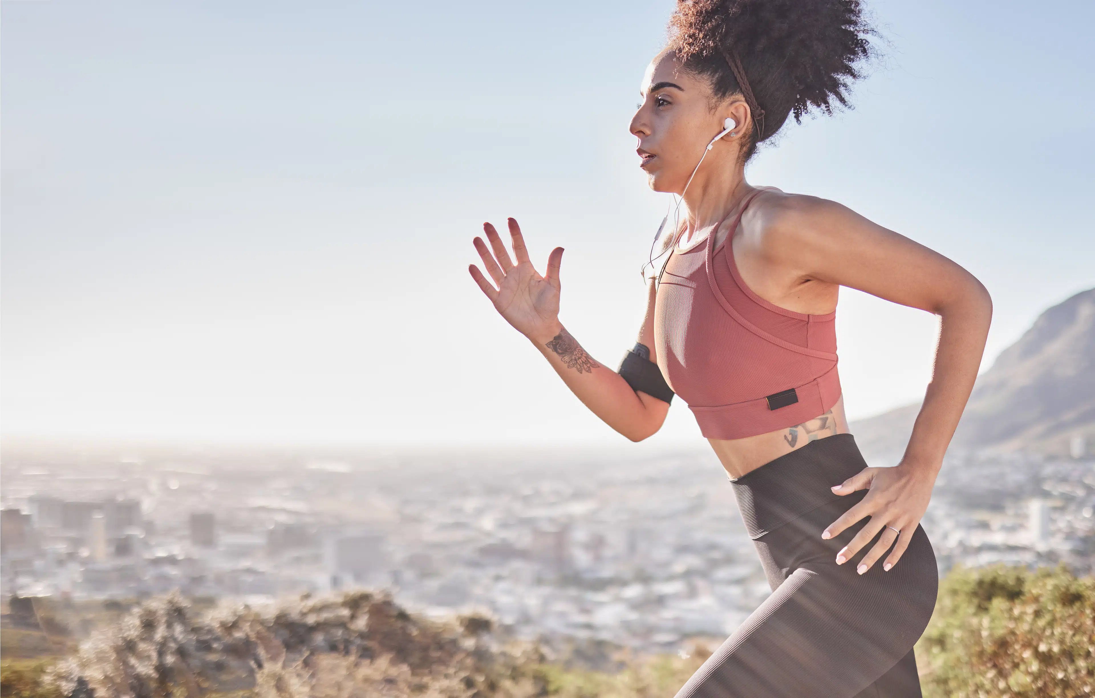 Woman running outdoors wearing headphones