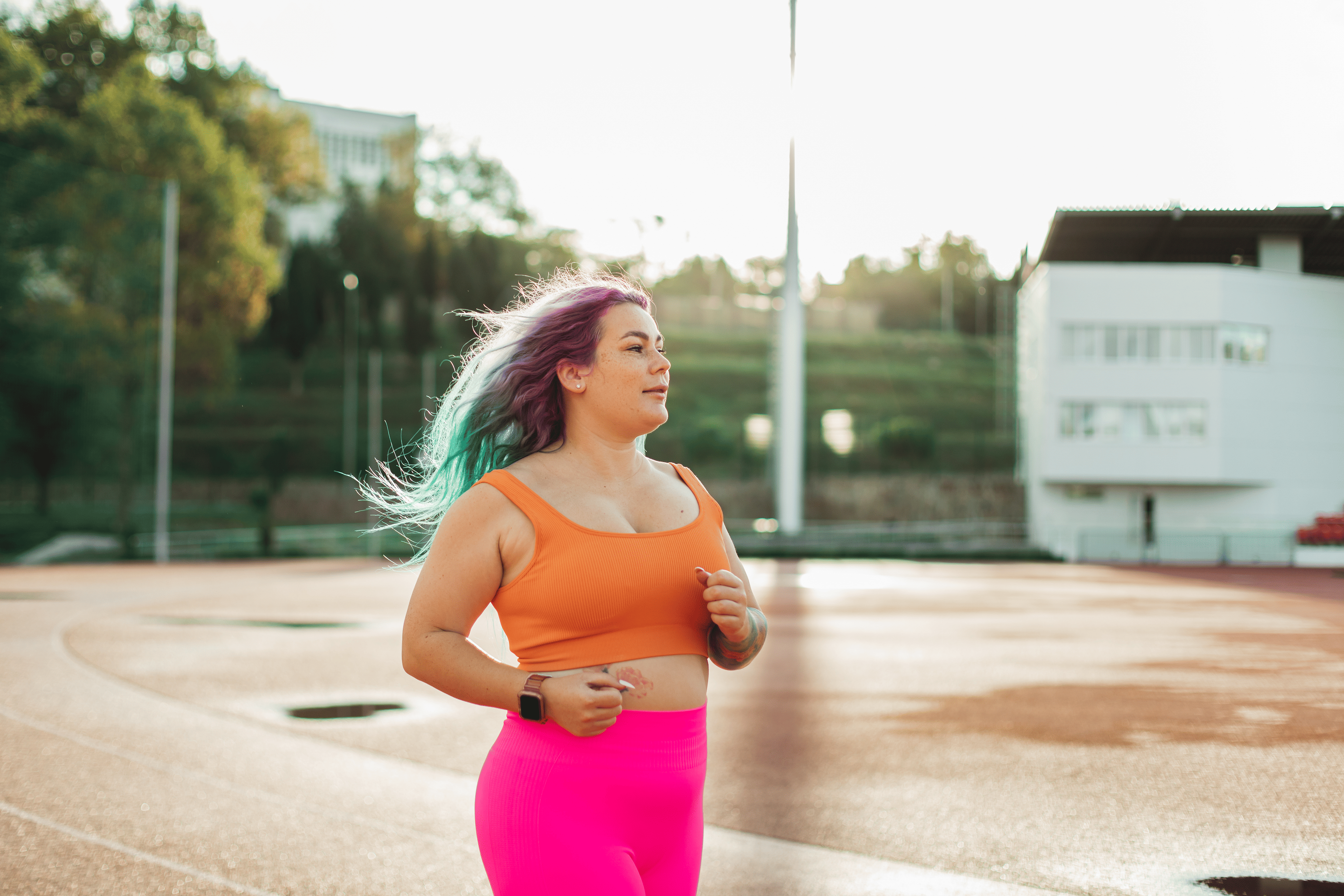 Woman working on a beginner running goal at the track.