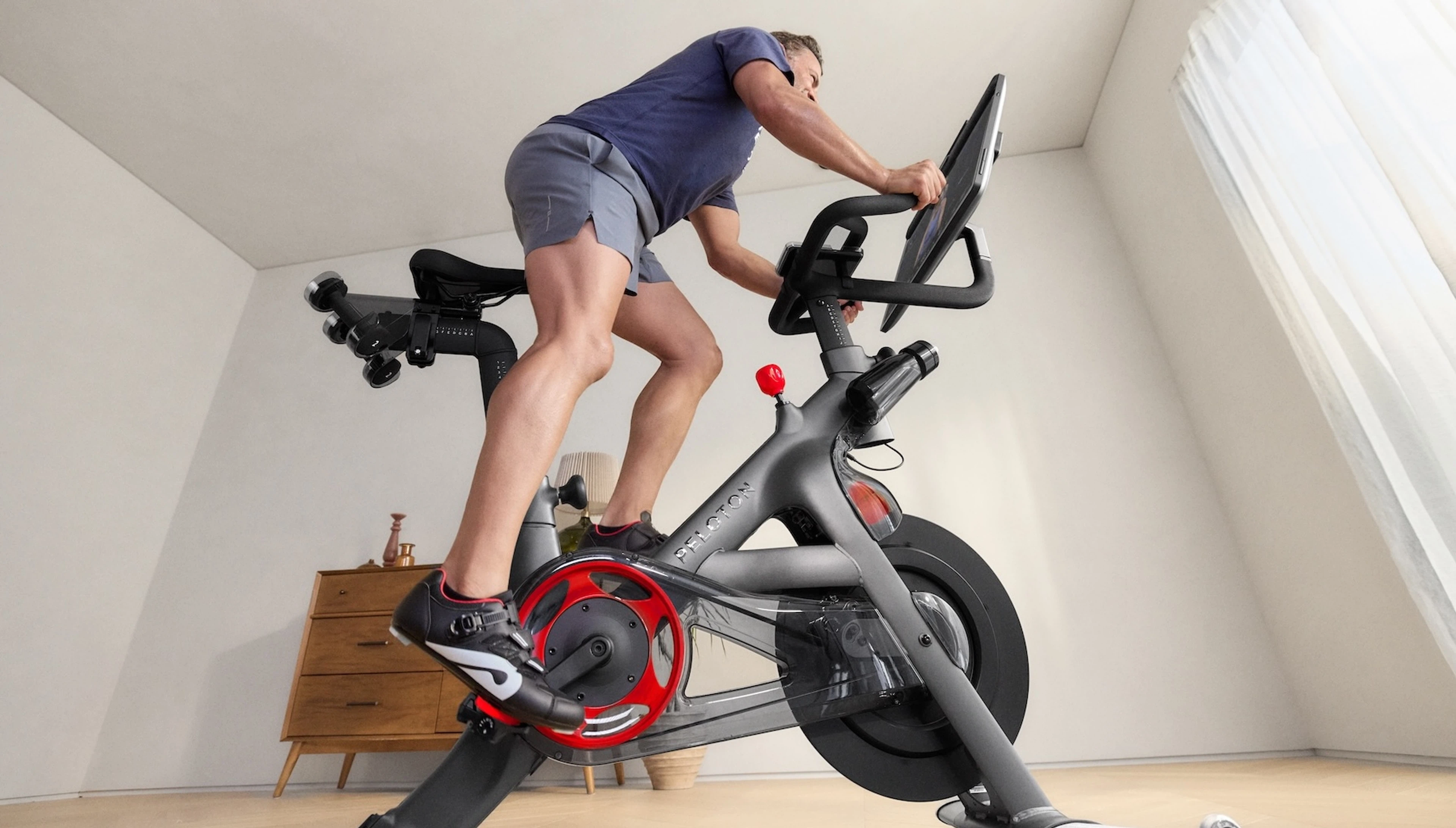 Man taking a Peloton class on Peloton equipment