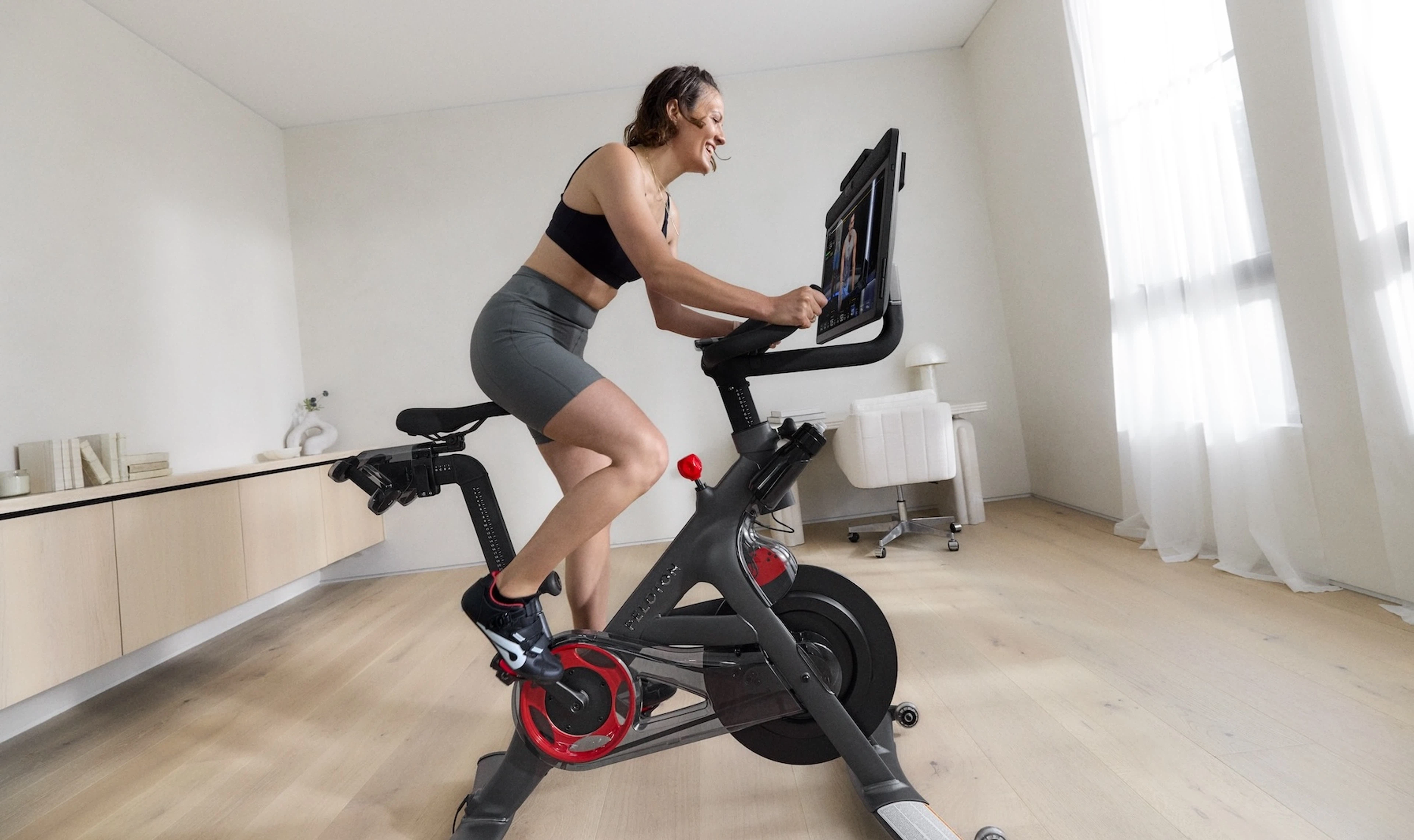 Woman taking a cycling class on a Peloton Bike