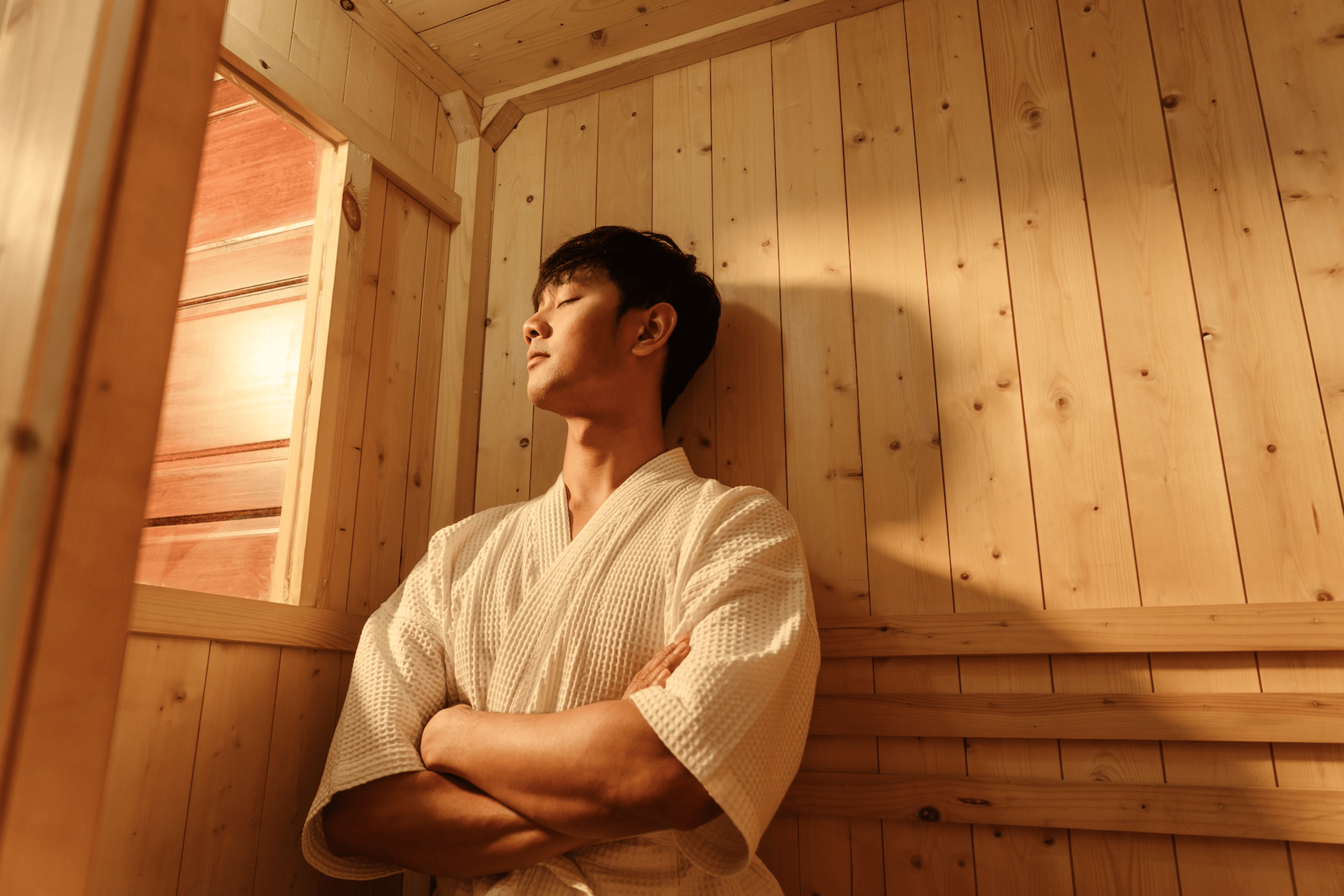 A man relaxing in the sauna after a workout.