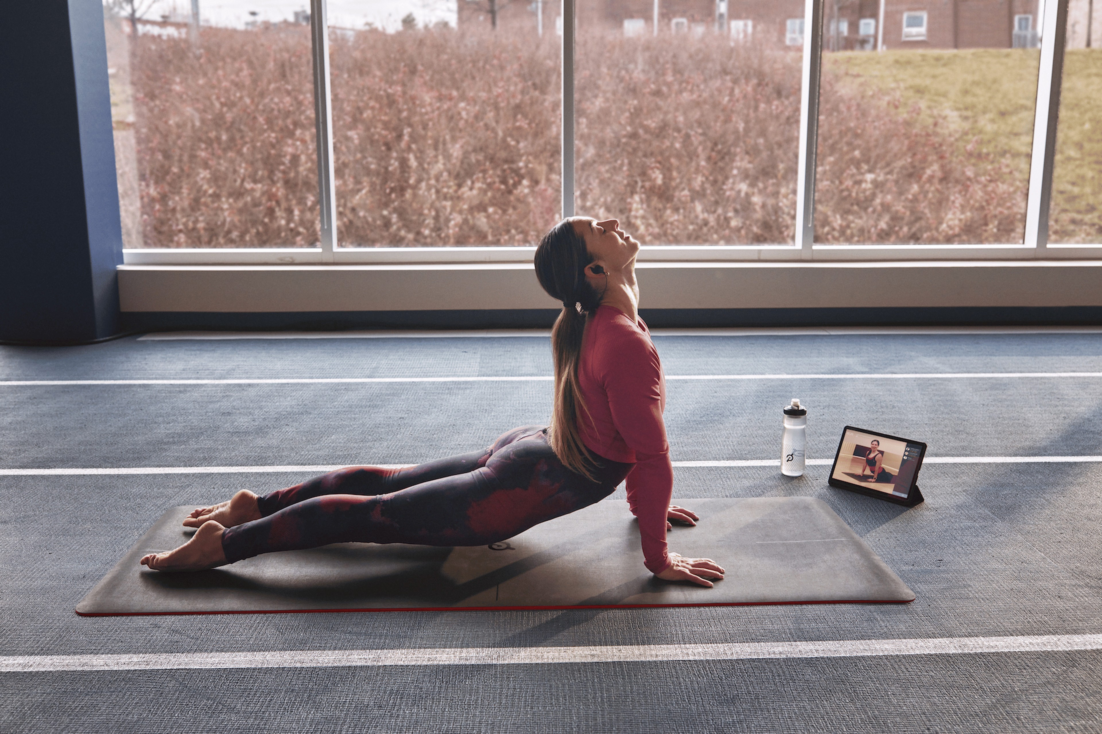 Woman practices a Peloton Yoga class 