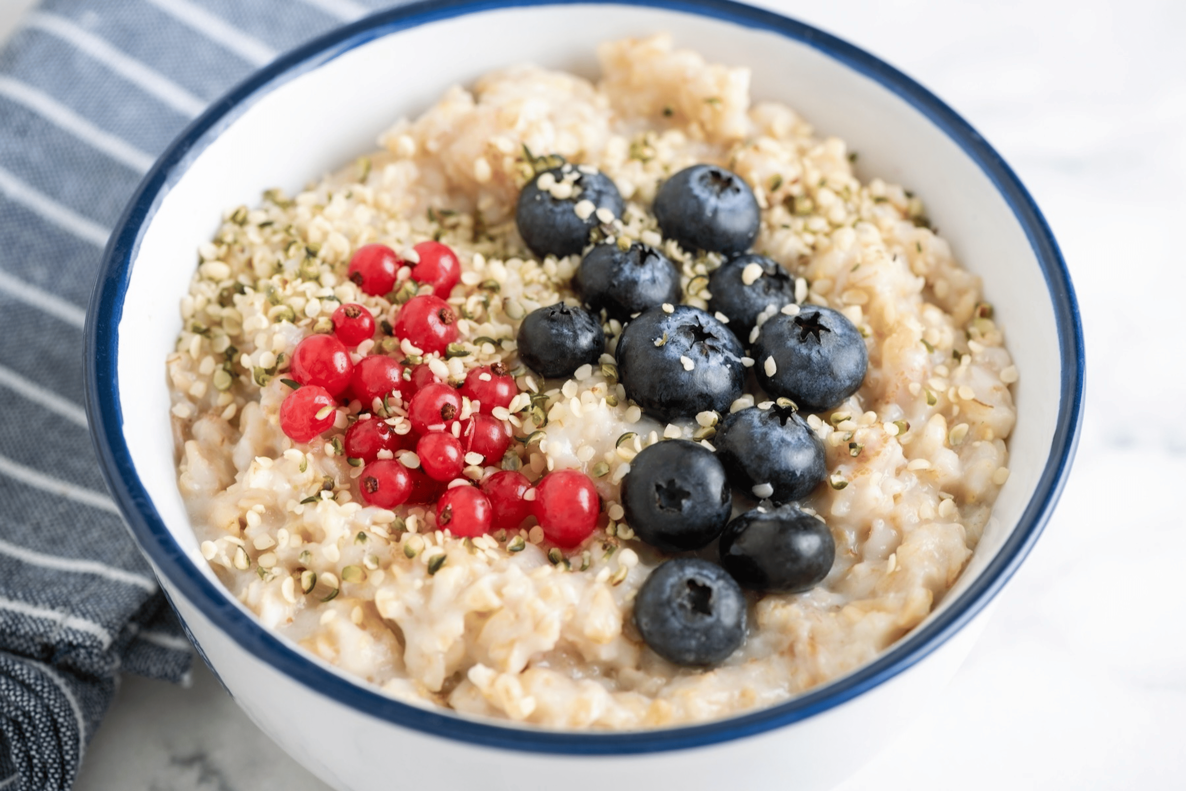 Oatmeal porridge topped with hemp seeds (which are a non-meat protein source) as well as berries.