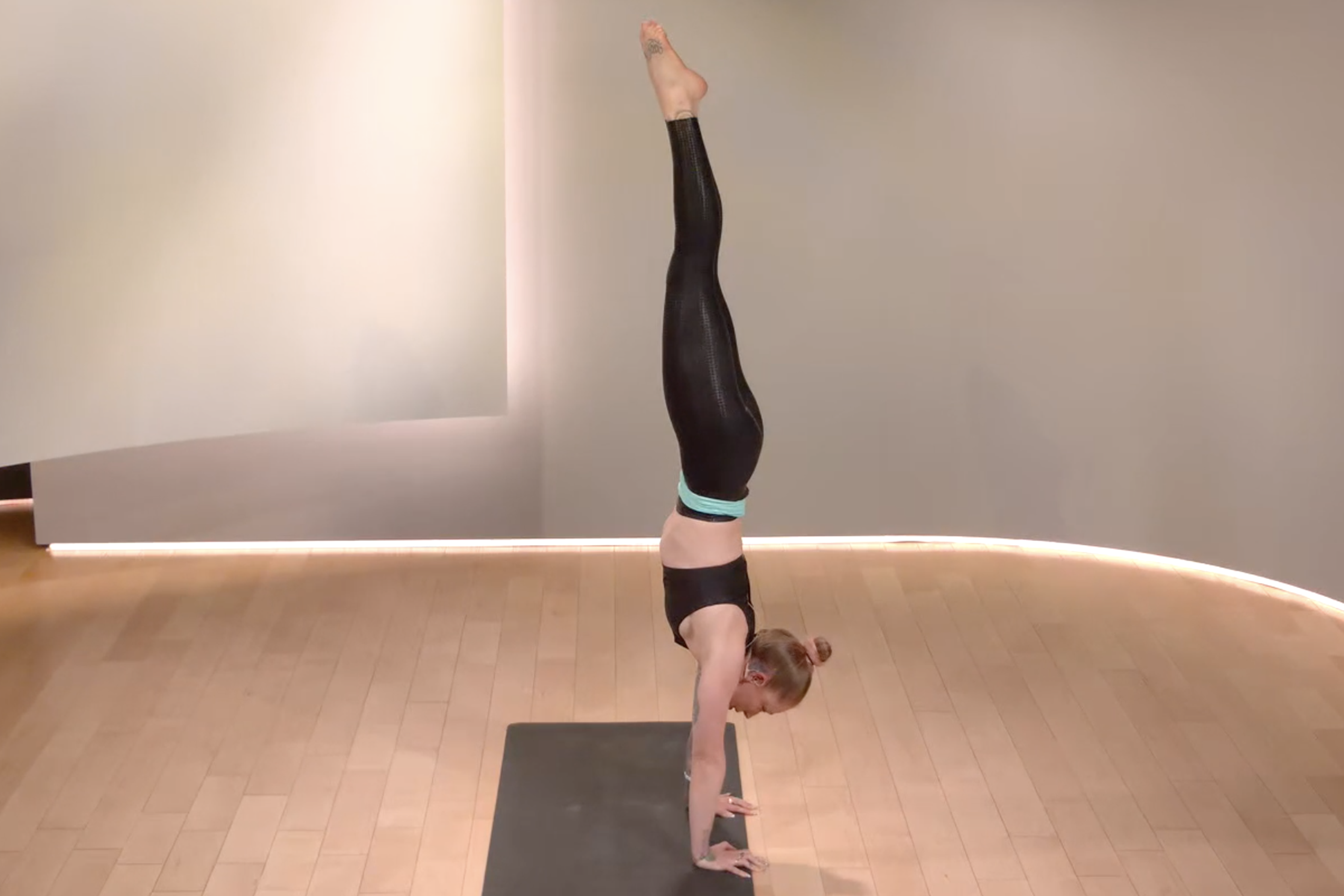 Woman does a handstand, how to do a handstand