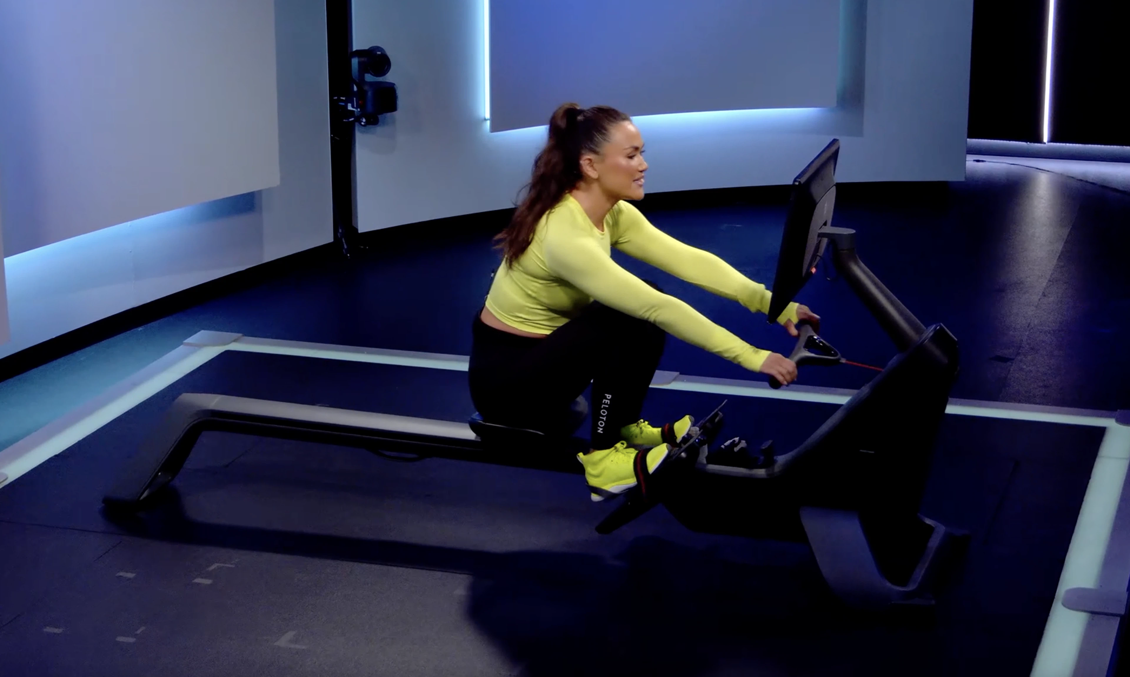 Peloton Row instructor Katie Wang demonstrates proper rowing machine form for the catch