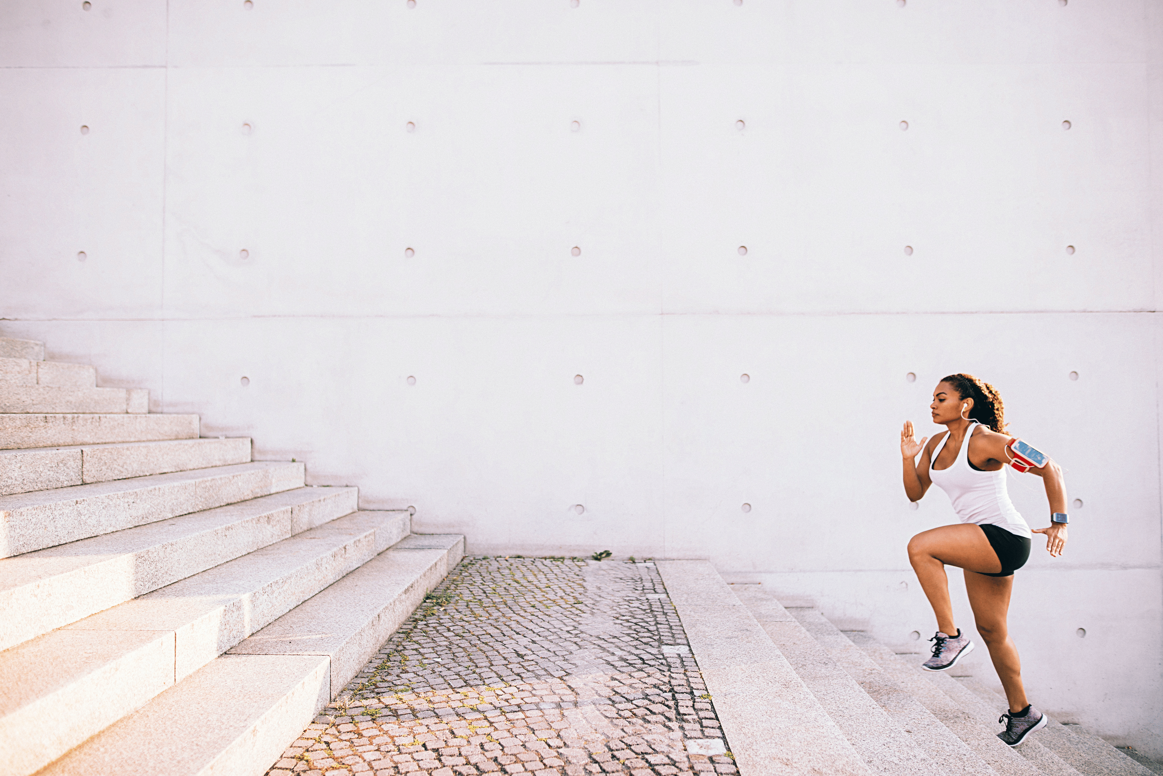 Woman running up stairs — Getty Images