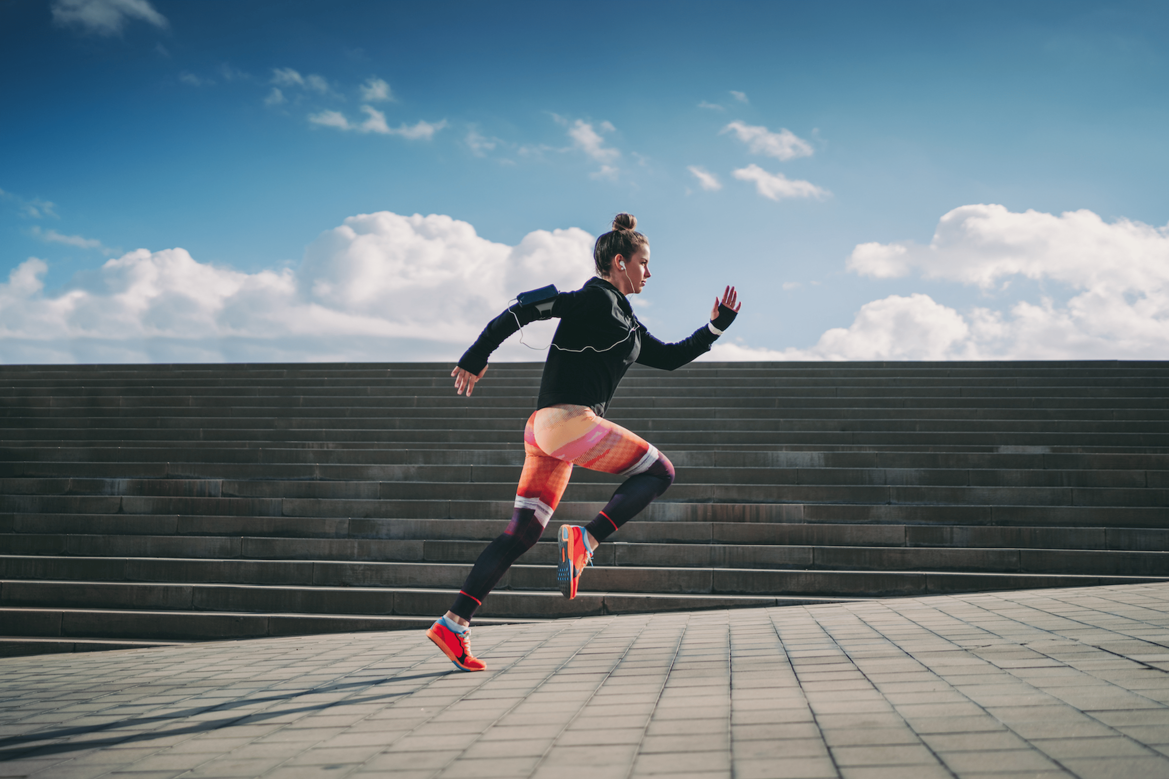 Woman practices bounding while running, a plyometric exercise