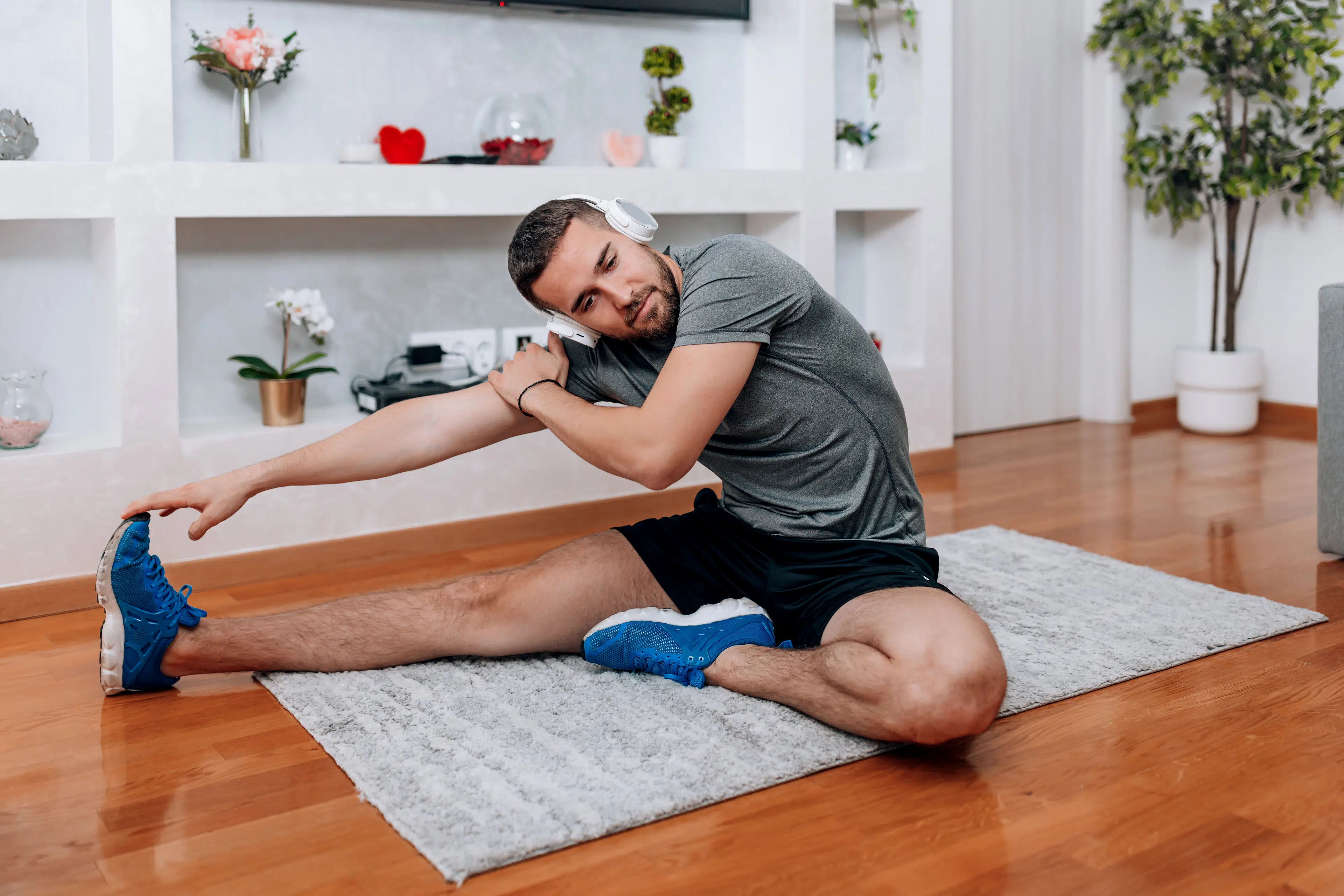 Man stretches at home