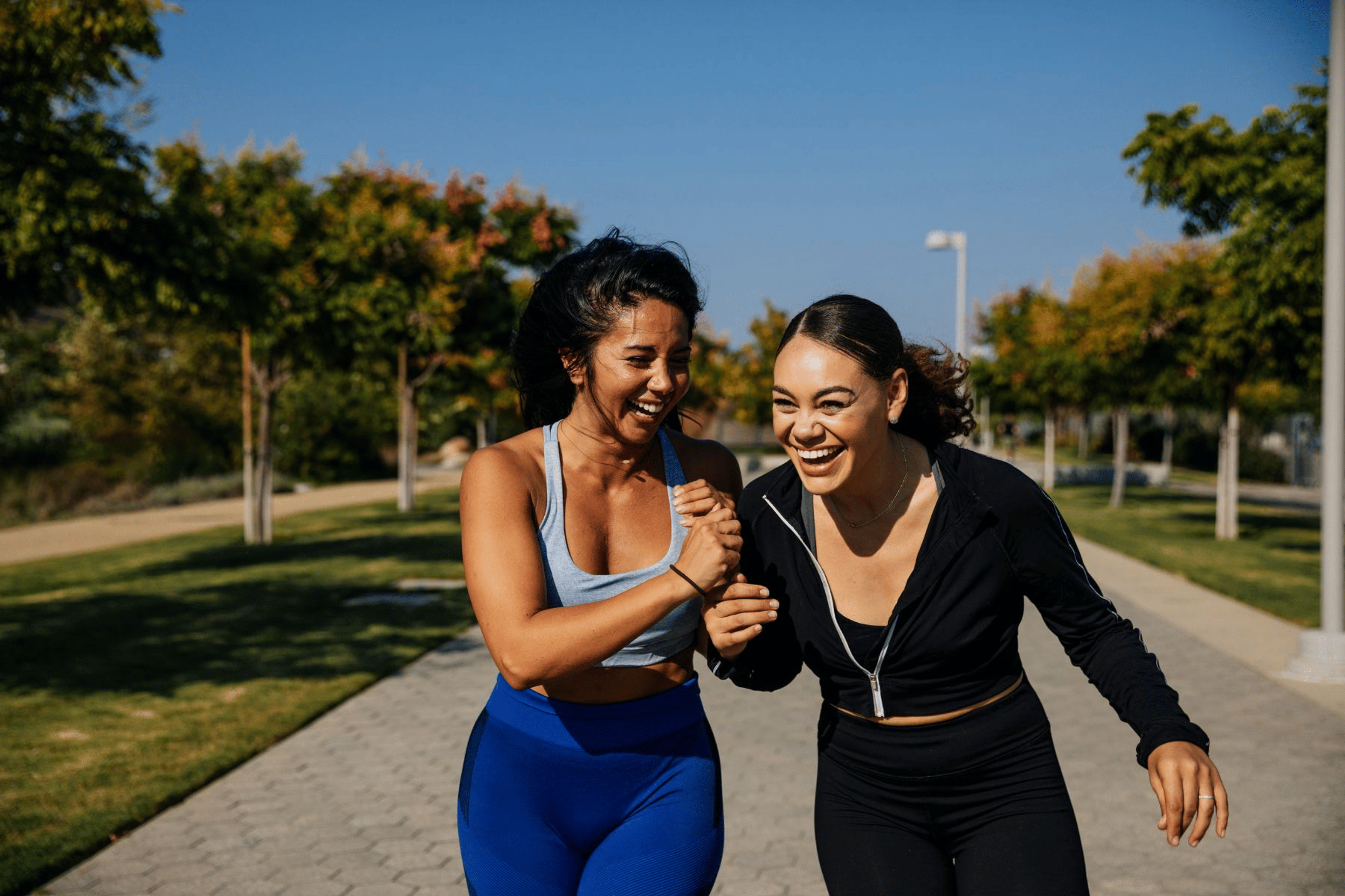 Two women exercising and laughing outside