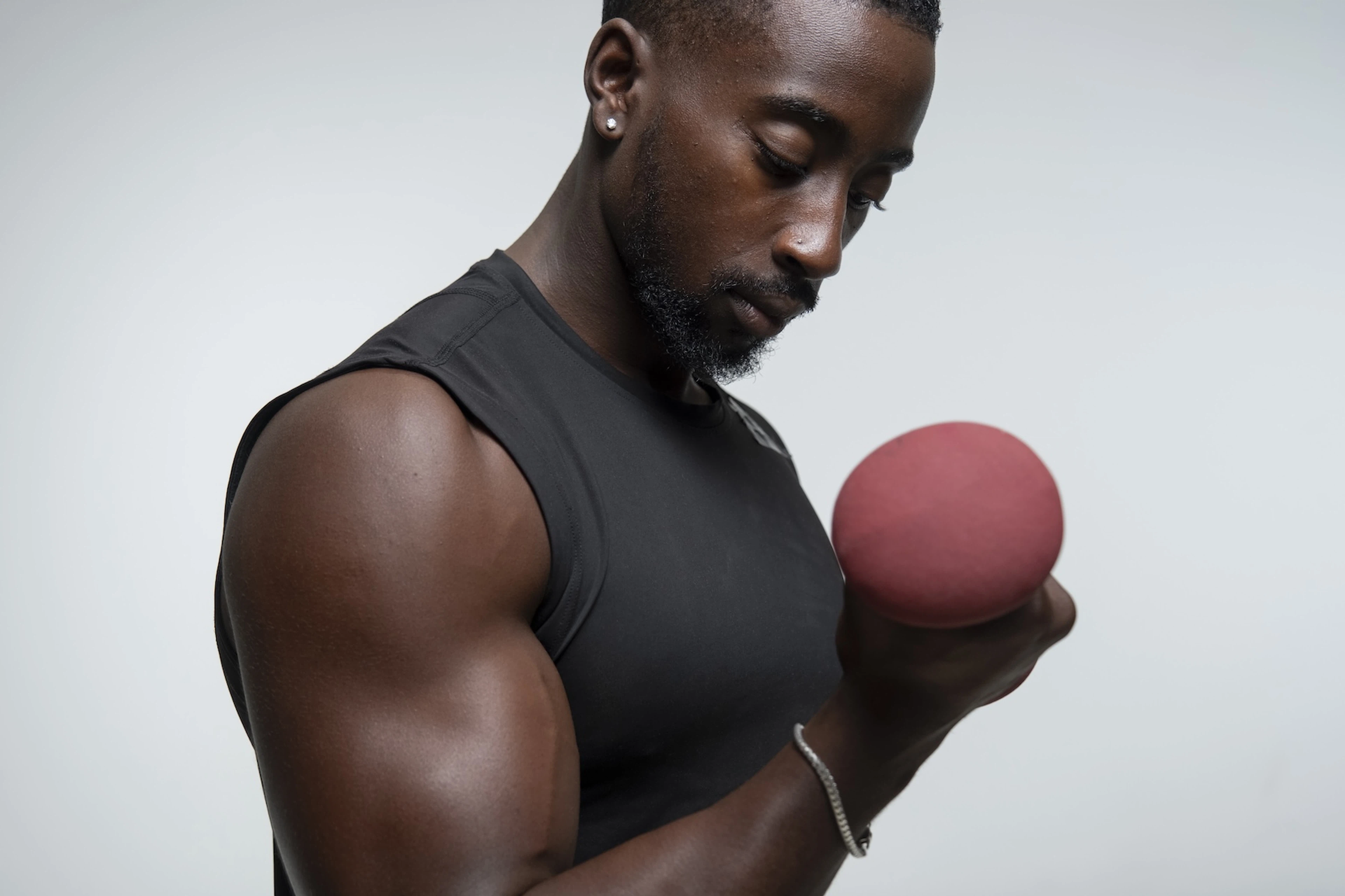 A man lifting a dumbbell in a bicep curl.