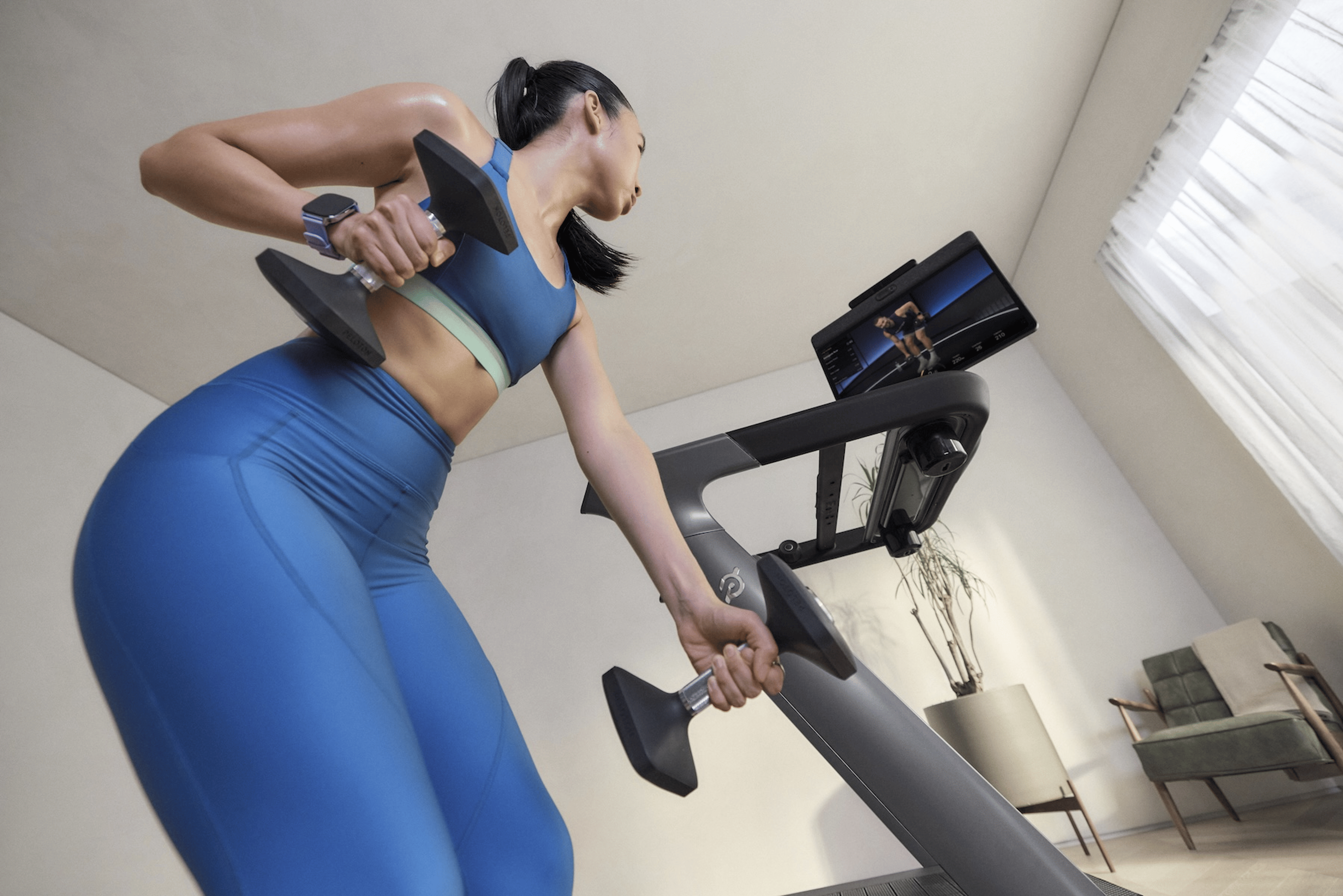 Woman training with Peloton wearing an integrated wearable