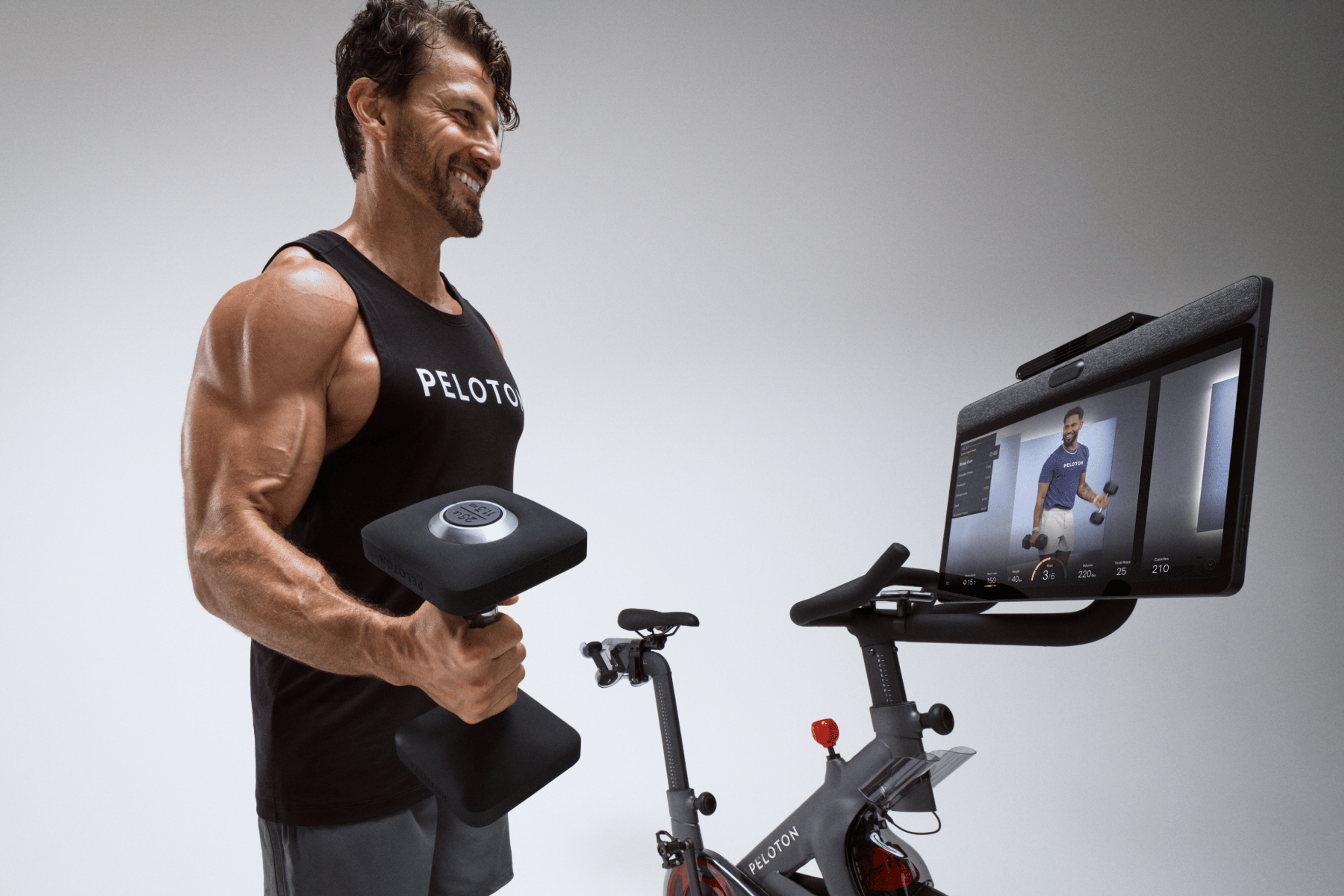 Peloton guest instructor Tim Robards strength training using the Peloton Cross Training Series Bike+ 