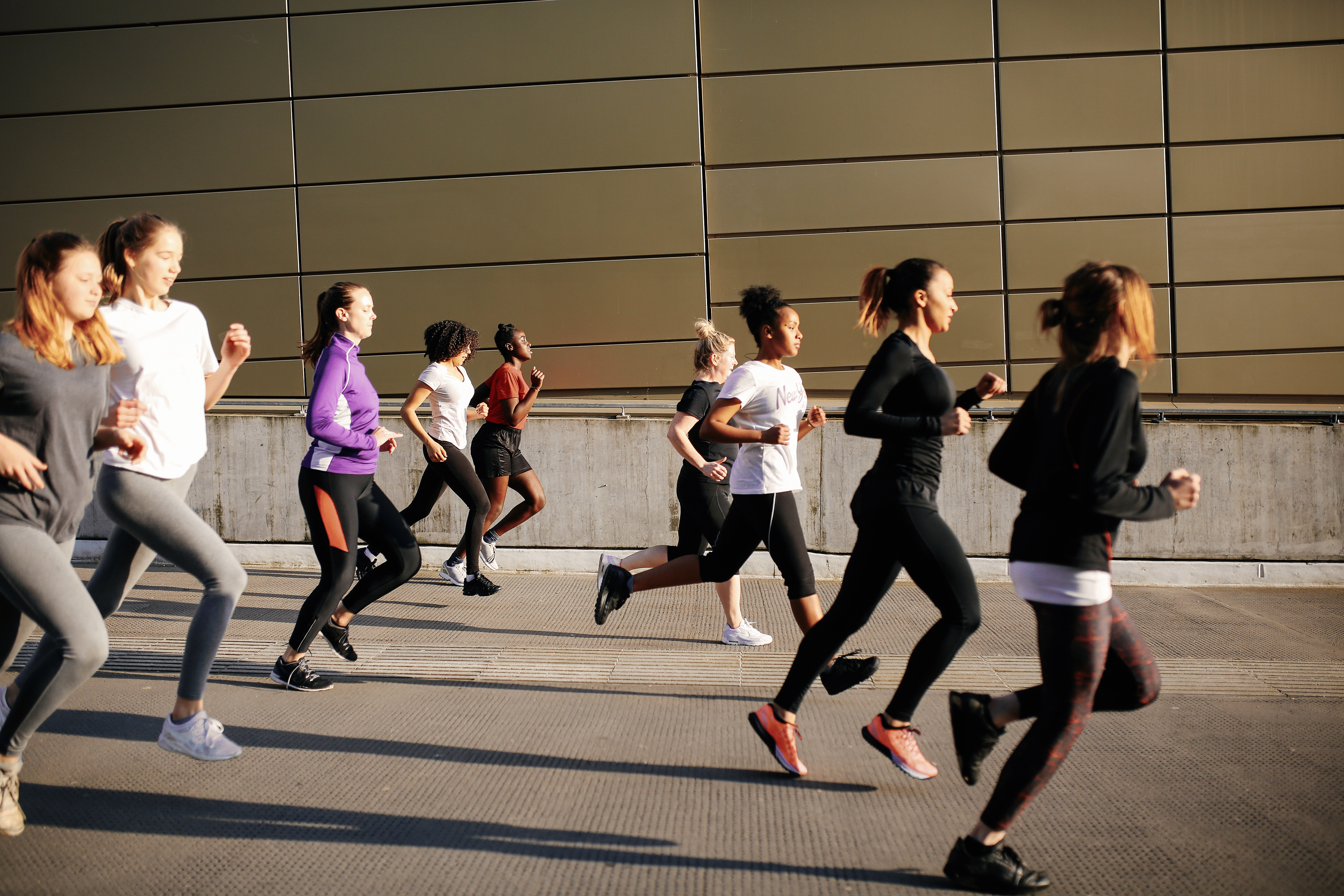 Group of people running in a city
