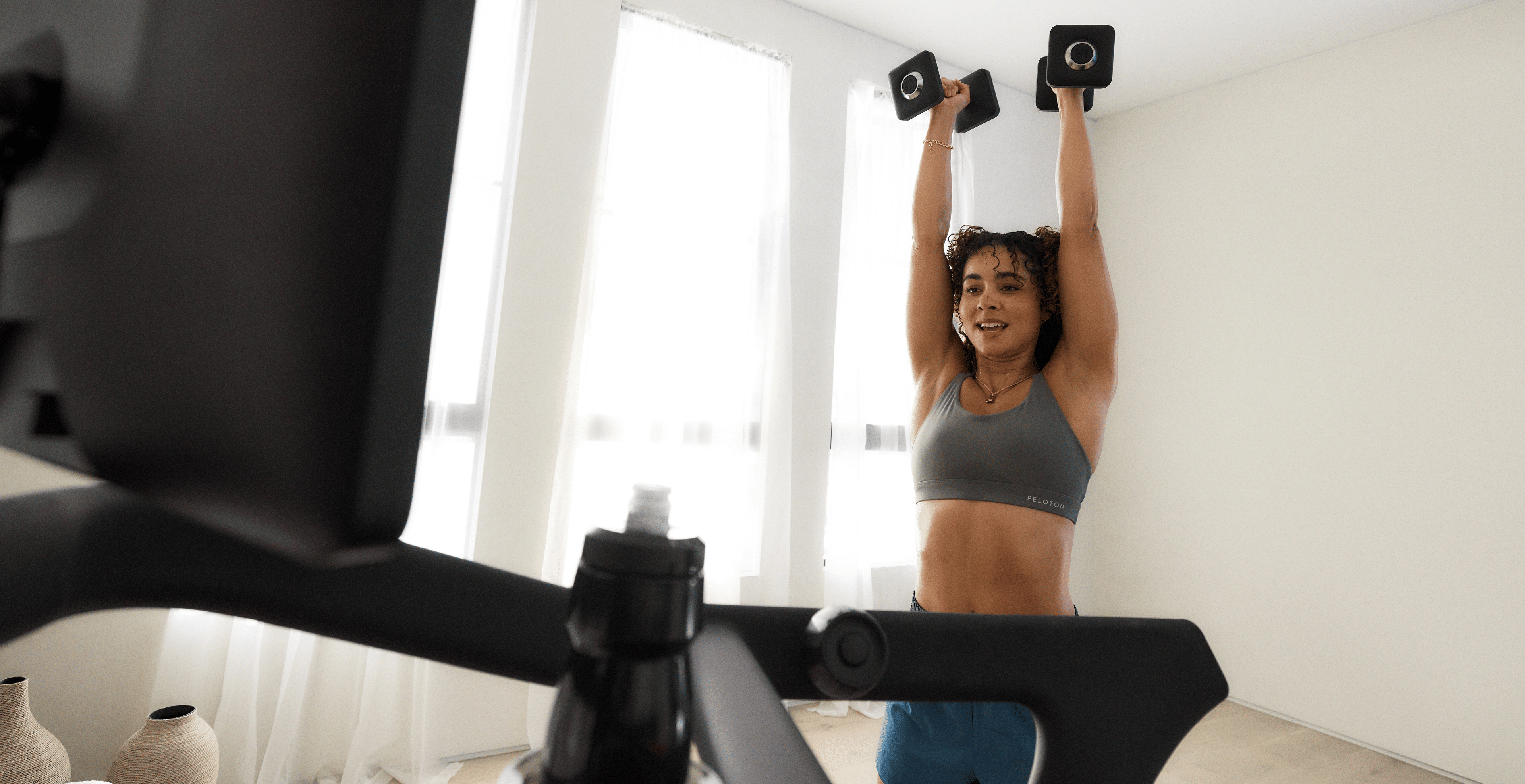 Woman strength training with Peloton