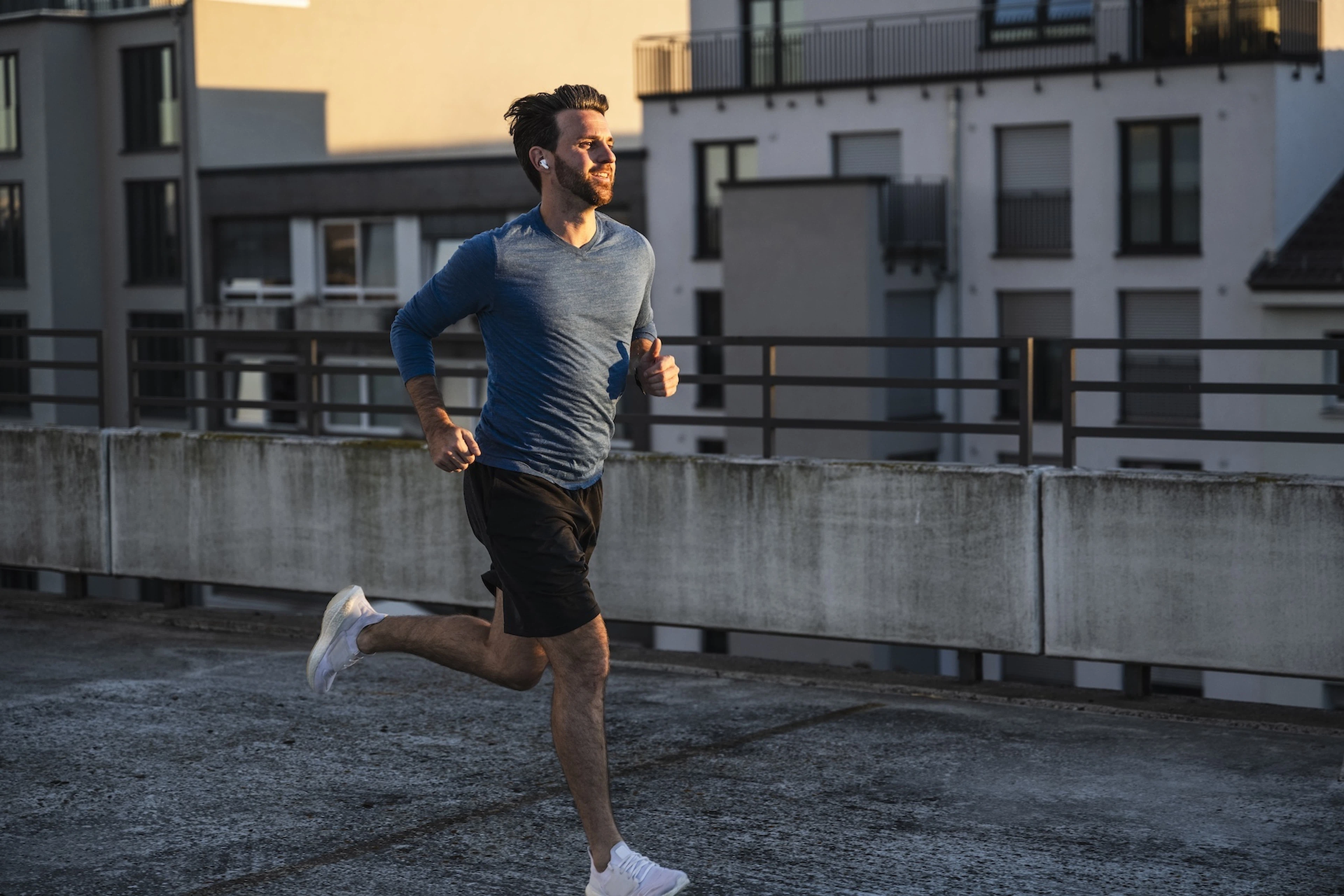 A man running happily outside at sunset. Learn how to cultivate a growth mindset in this article.