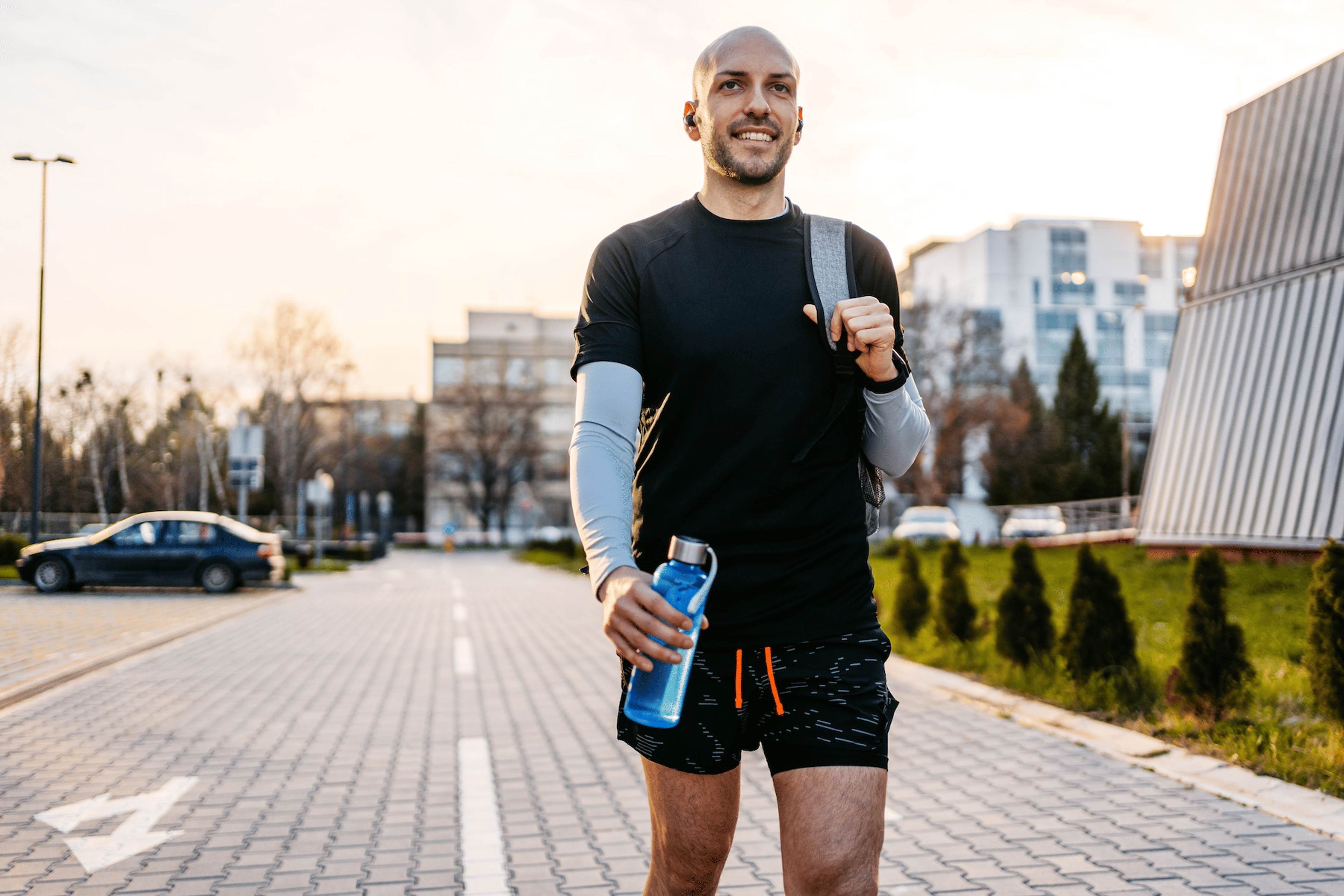 A man with confidence and high self-esteem walking outside after a workout.