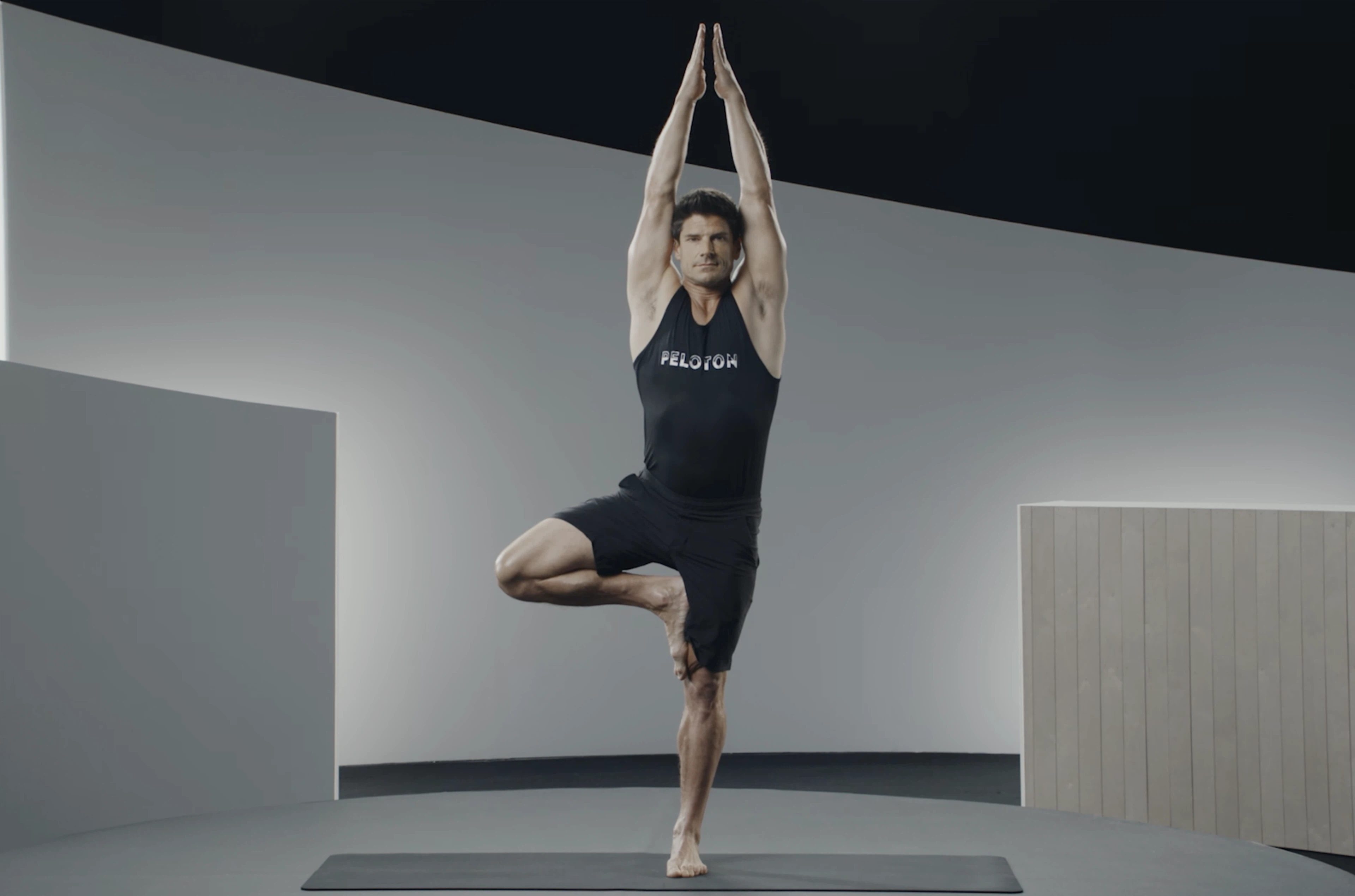 A man practices Tree Pose, yoga for anxiety