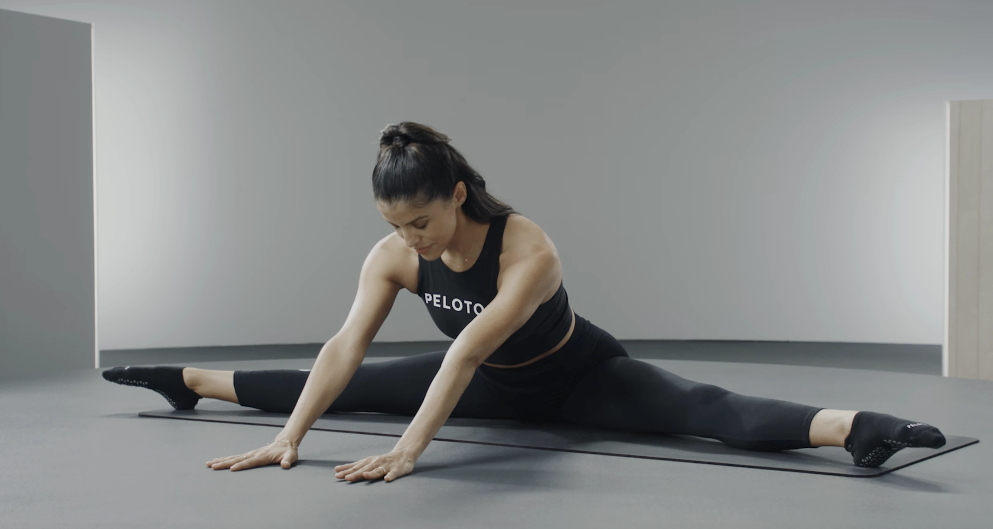 Hannah Corbin demonstrates a seated straddle stretch