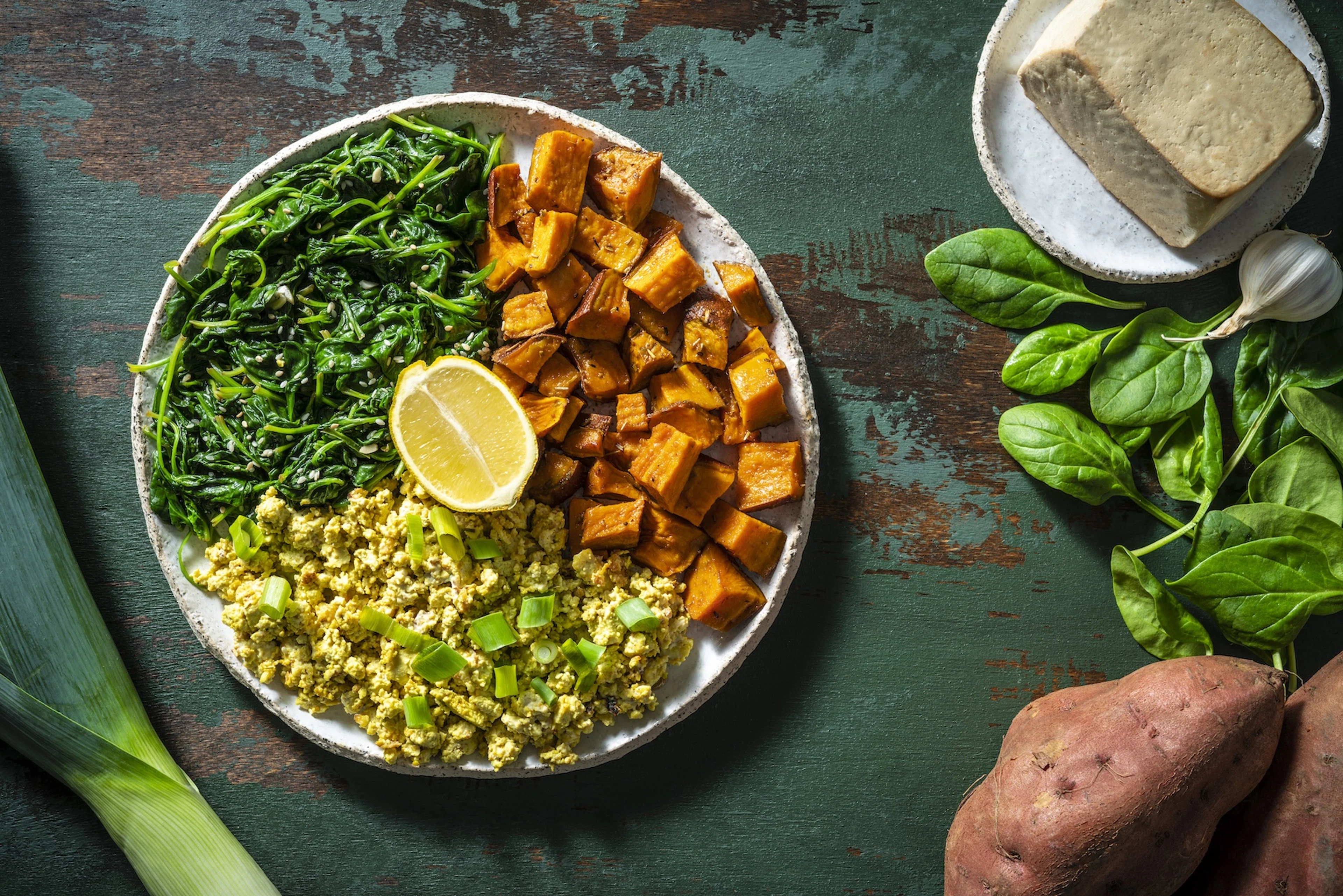 A plate with sweet potatoes, spinach, and scrambled tofu. Sweet potatoes and spinach are two of the best antioxidant foods.