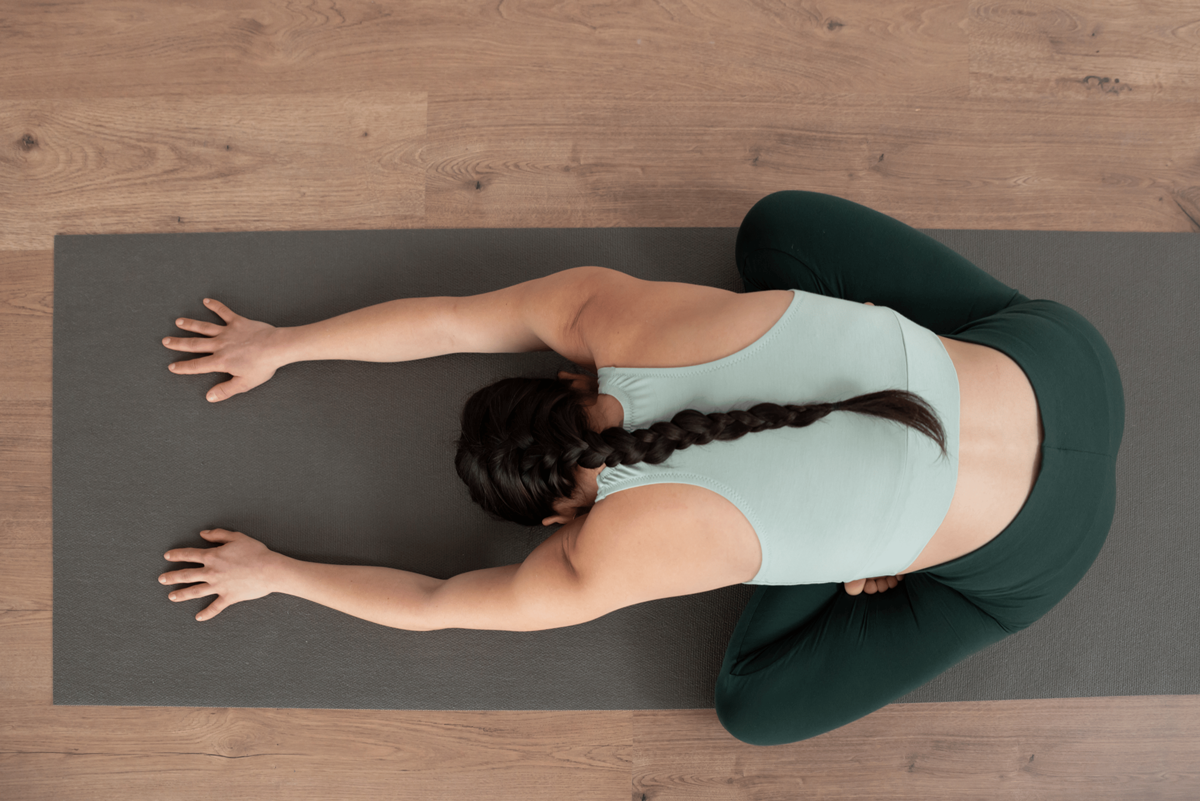Aerial view of woman sitting on a yoga mat