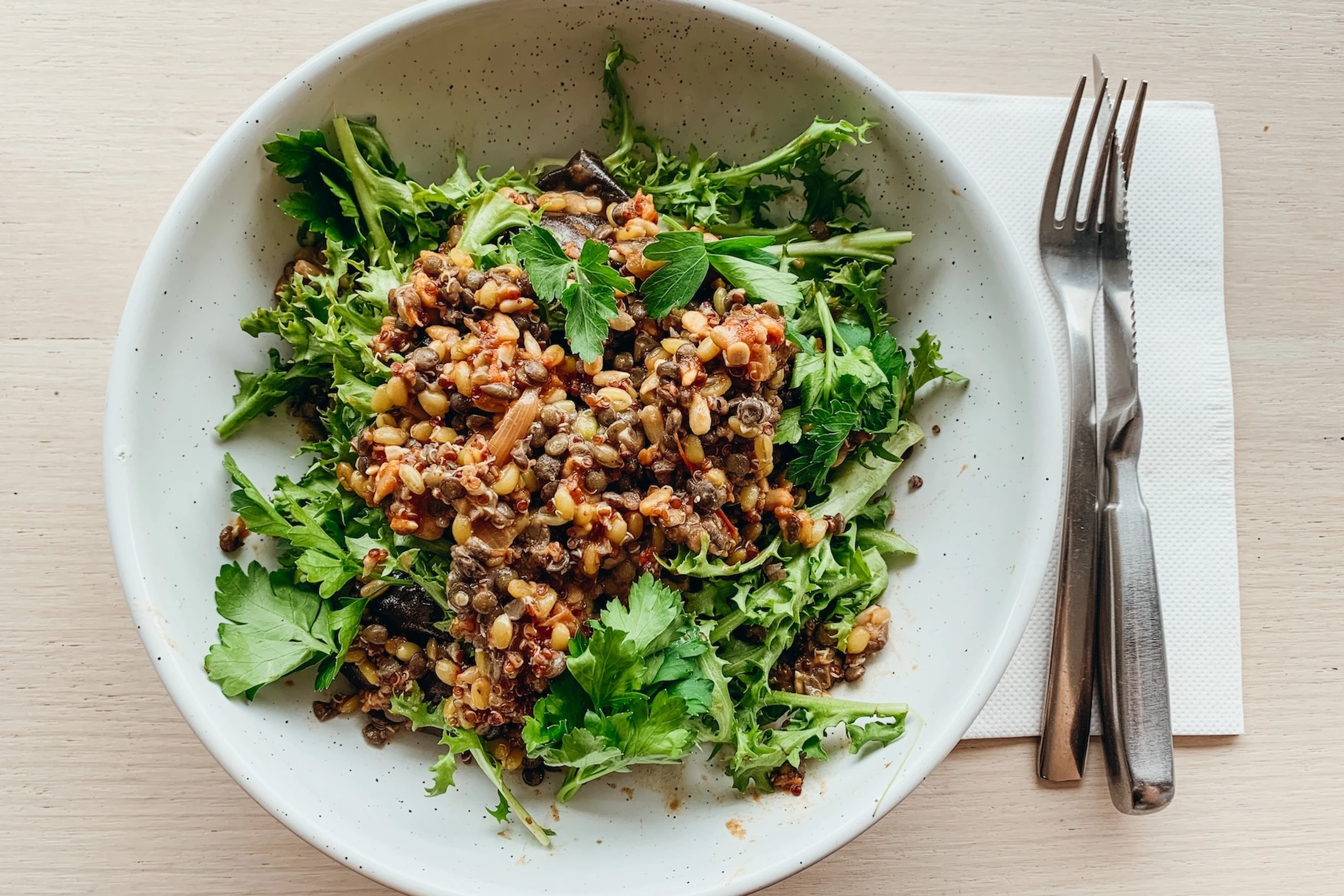 A lentil salad with greens and eggplant.