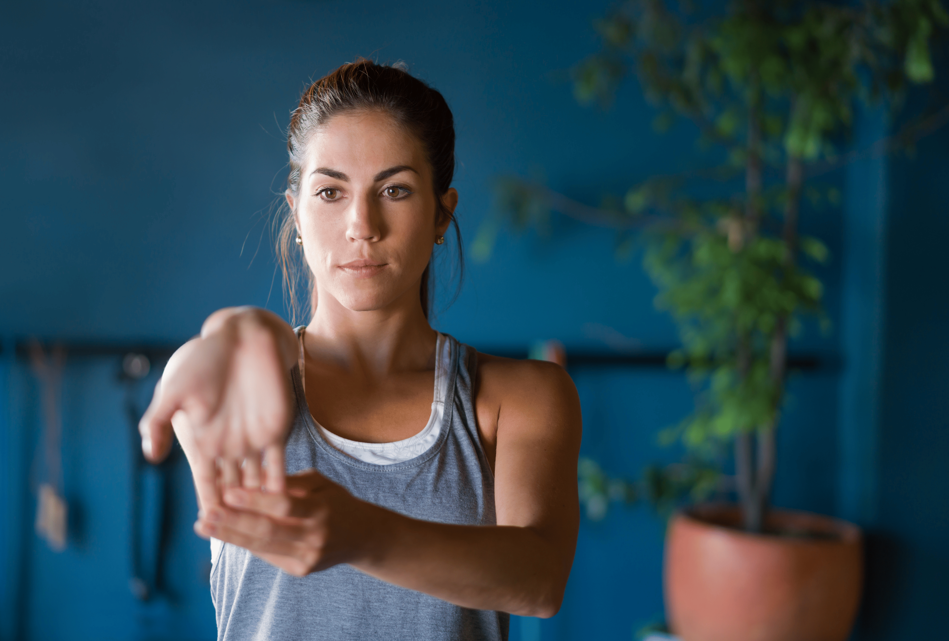 Woman performs a wrist stretch 