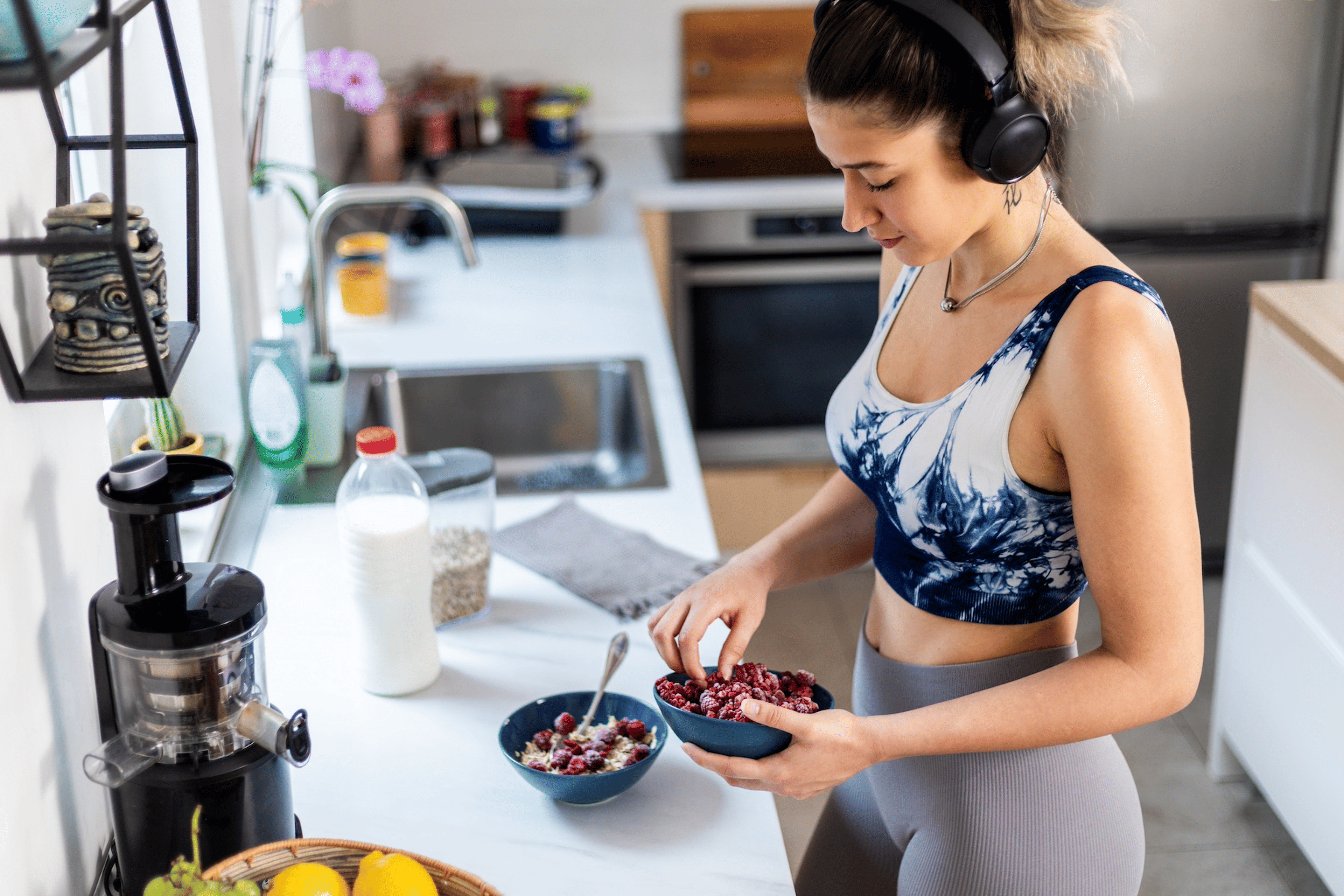 A woman preparing a bowl of fruit before going on a ride as part of her cycling nutrition strategy.