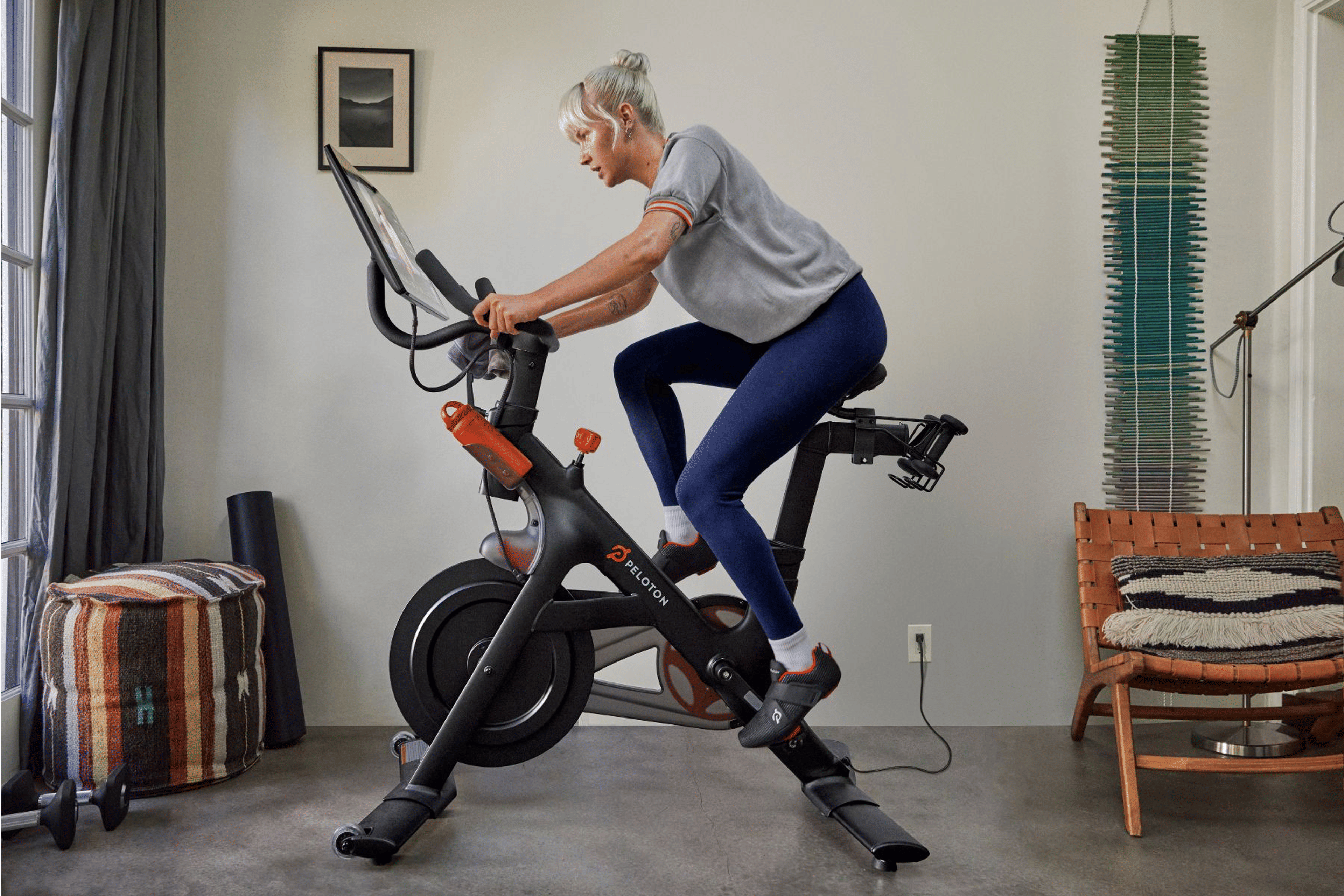Woman riding a Peloton Bike
