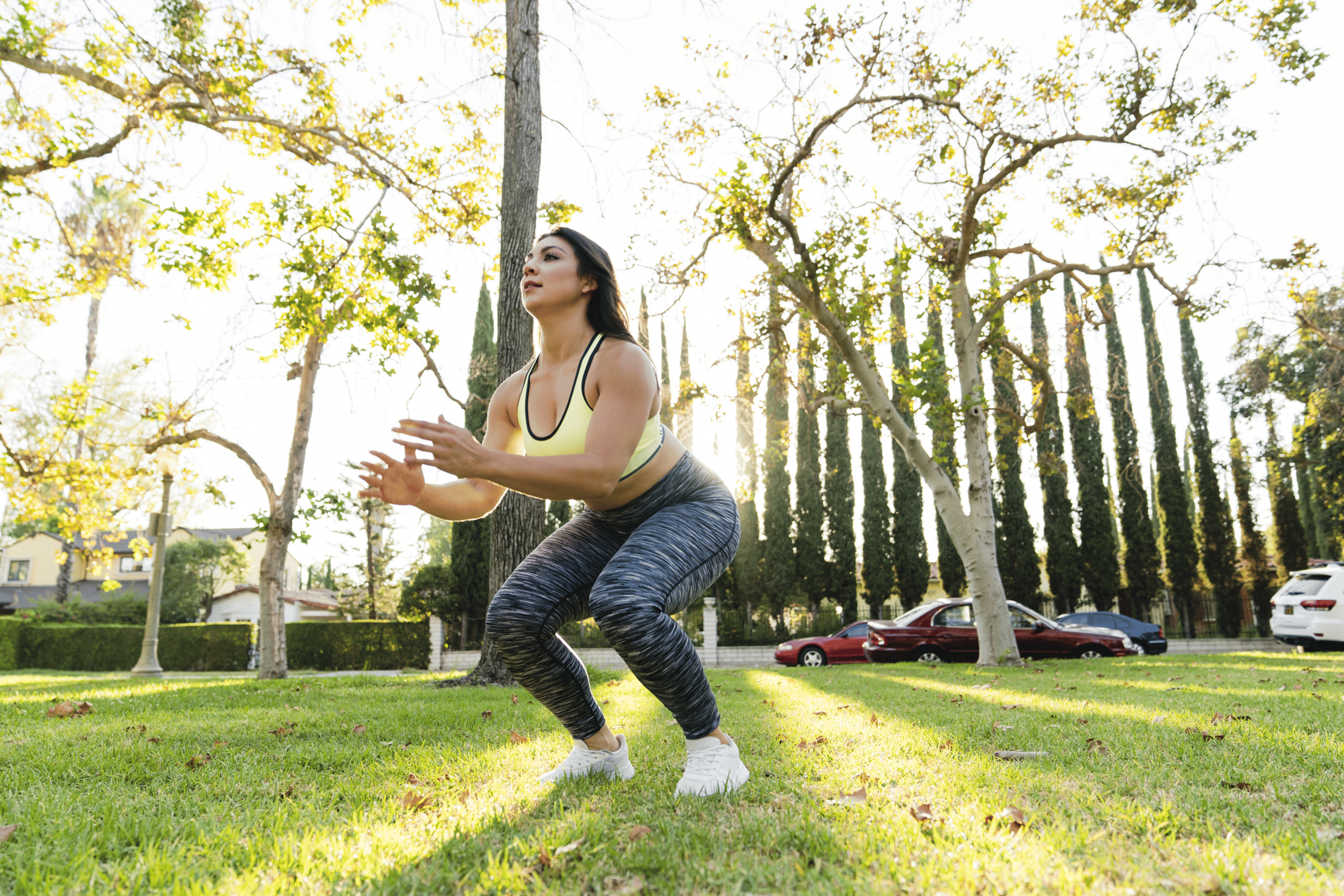 Woman does a jump squat outdoors 