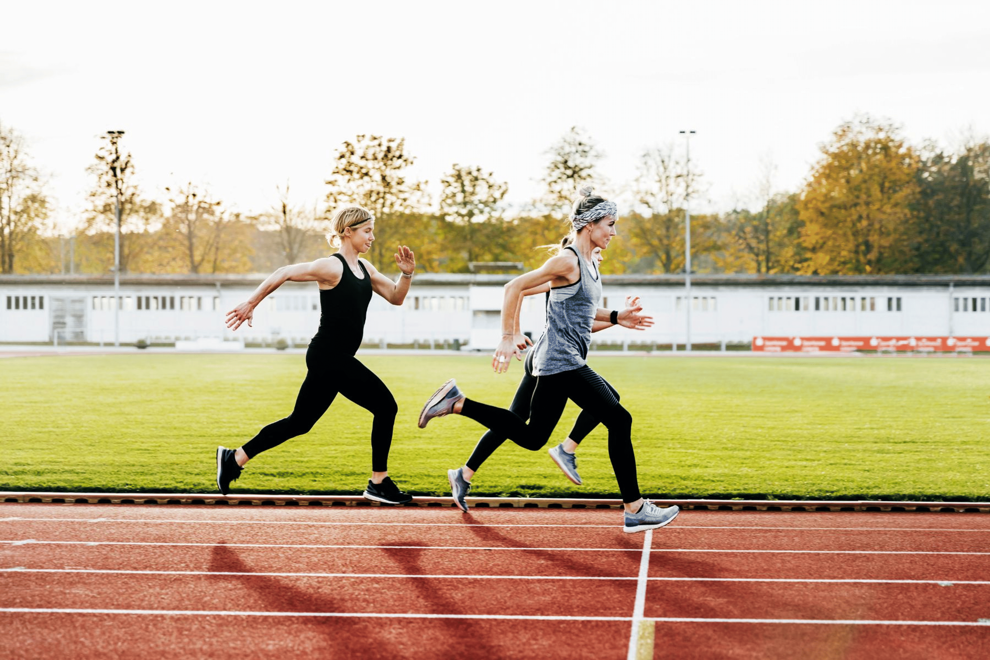 Three women running on a track