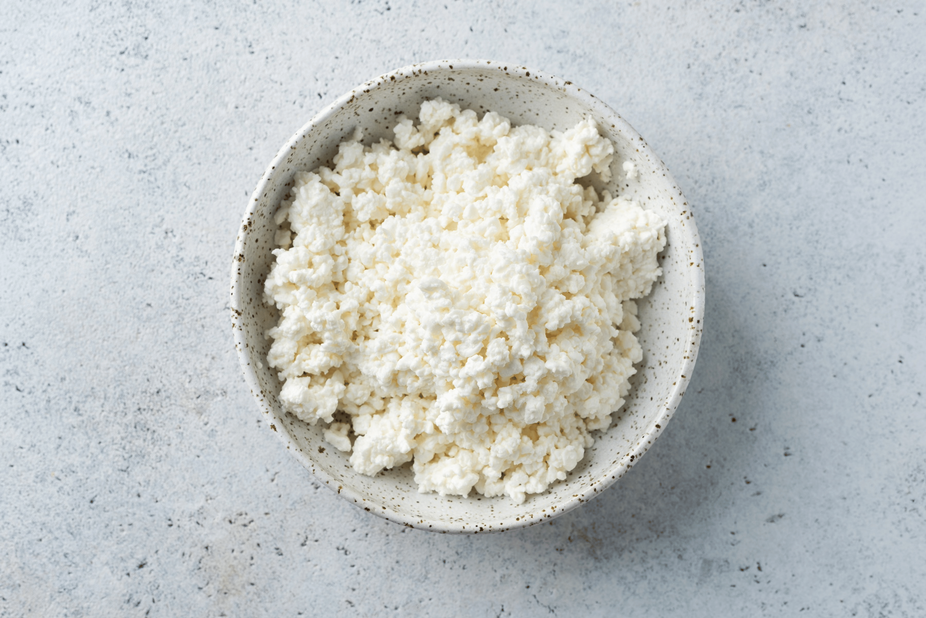 A bowl of cottage cheese, which is a high-protein snack.