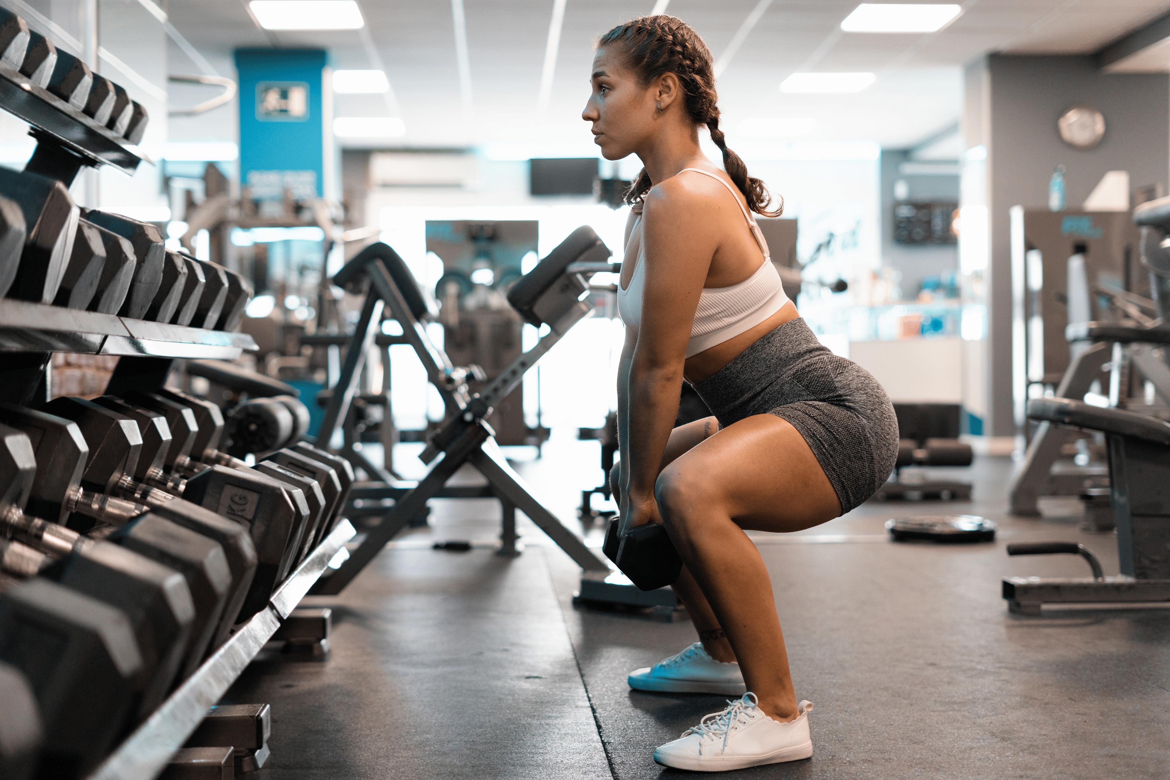 Woman does a squat exercise at the gym