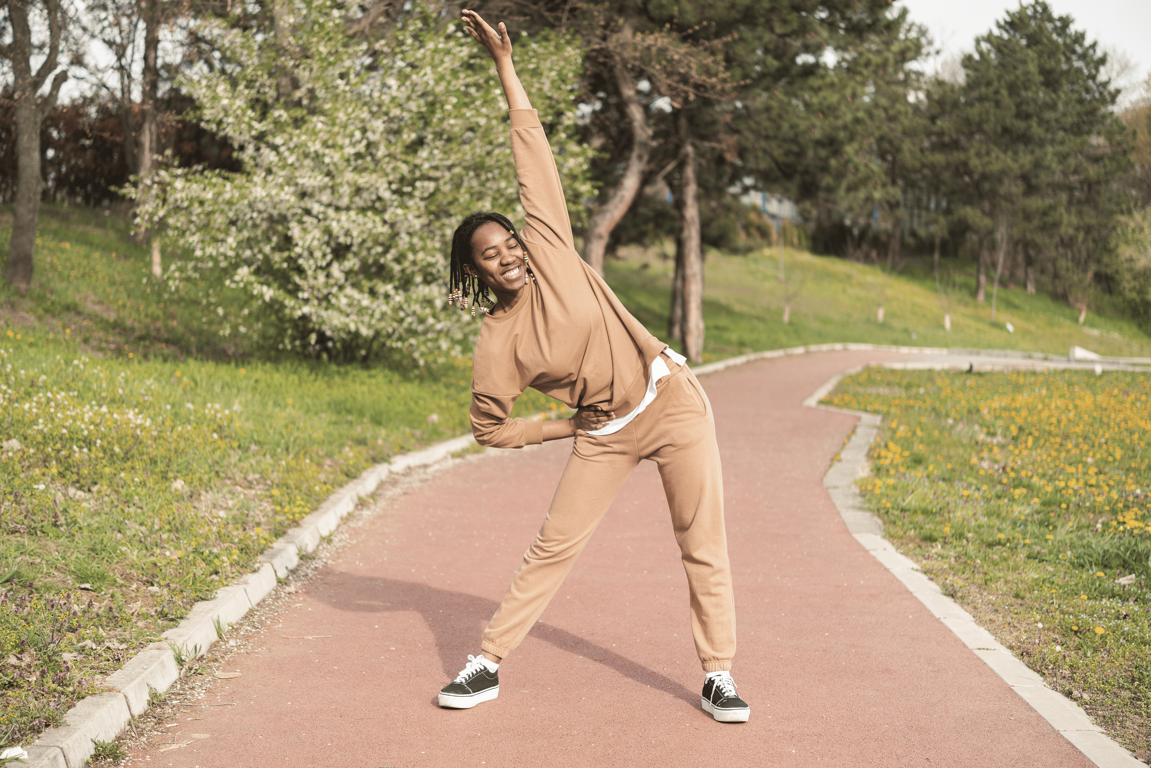 A girl does a side stretch outside