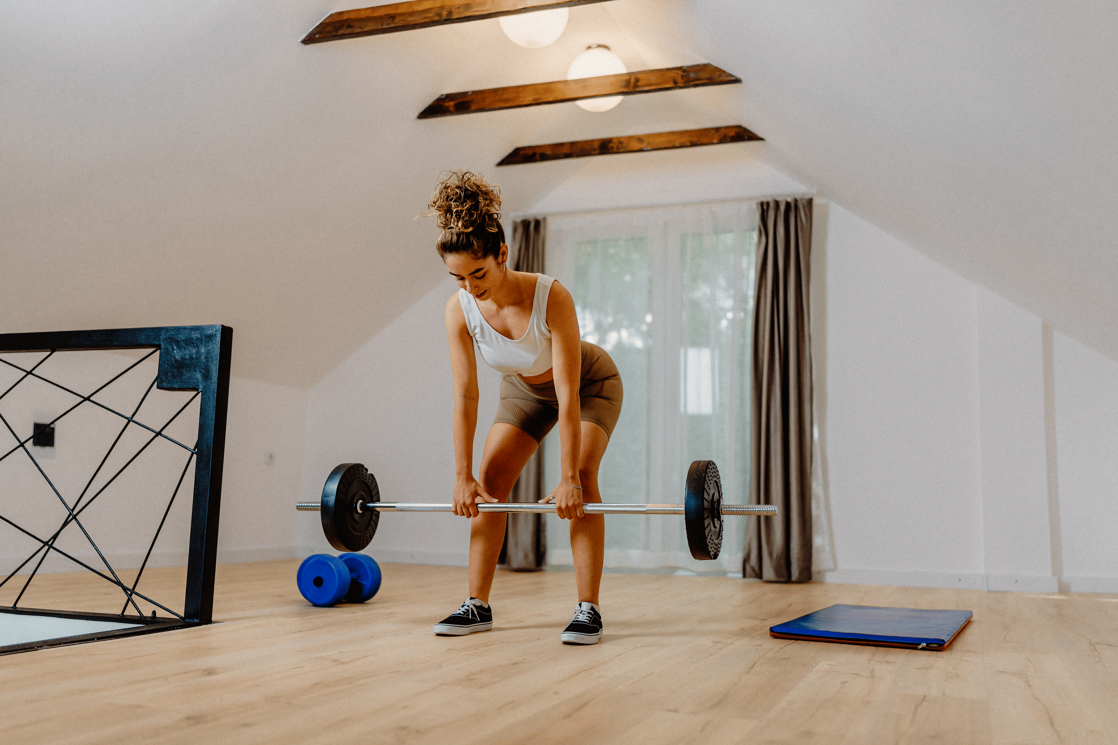 Woman does a deadlift exercise at home