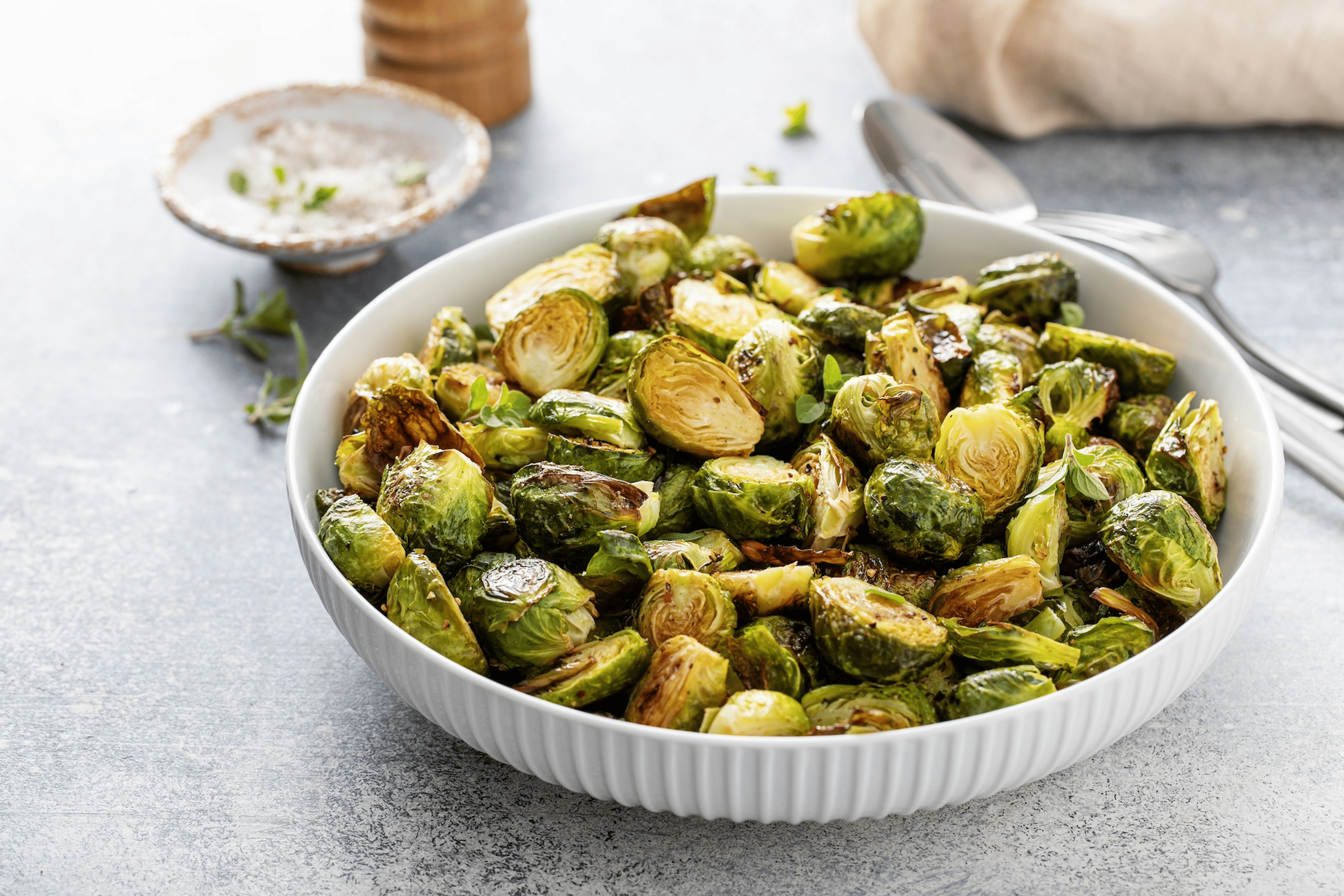 A big bowl of crispy Brussels sprouts, which are high-protein vegetables.