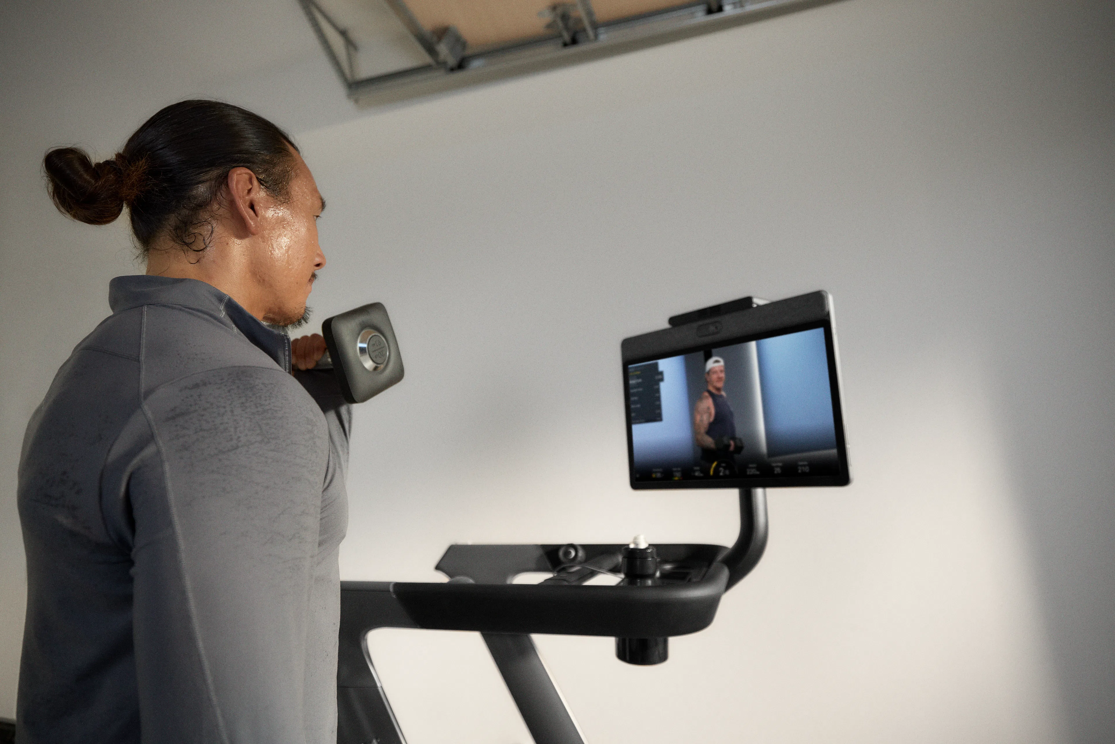 Man doing a Peloton strength benchmarks workout at home with his Peloton Tread+.