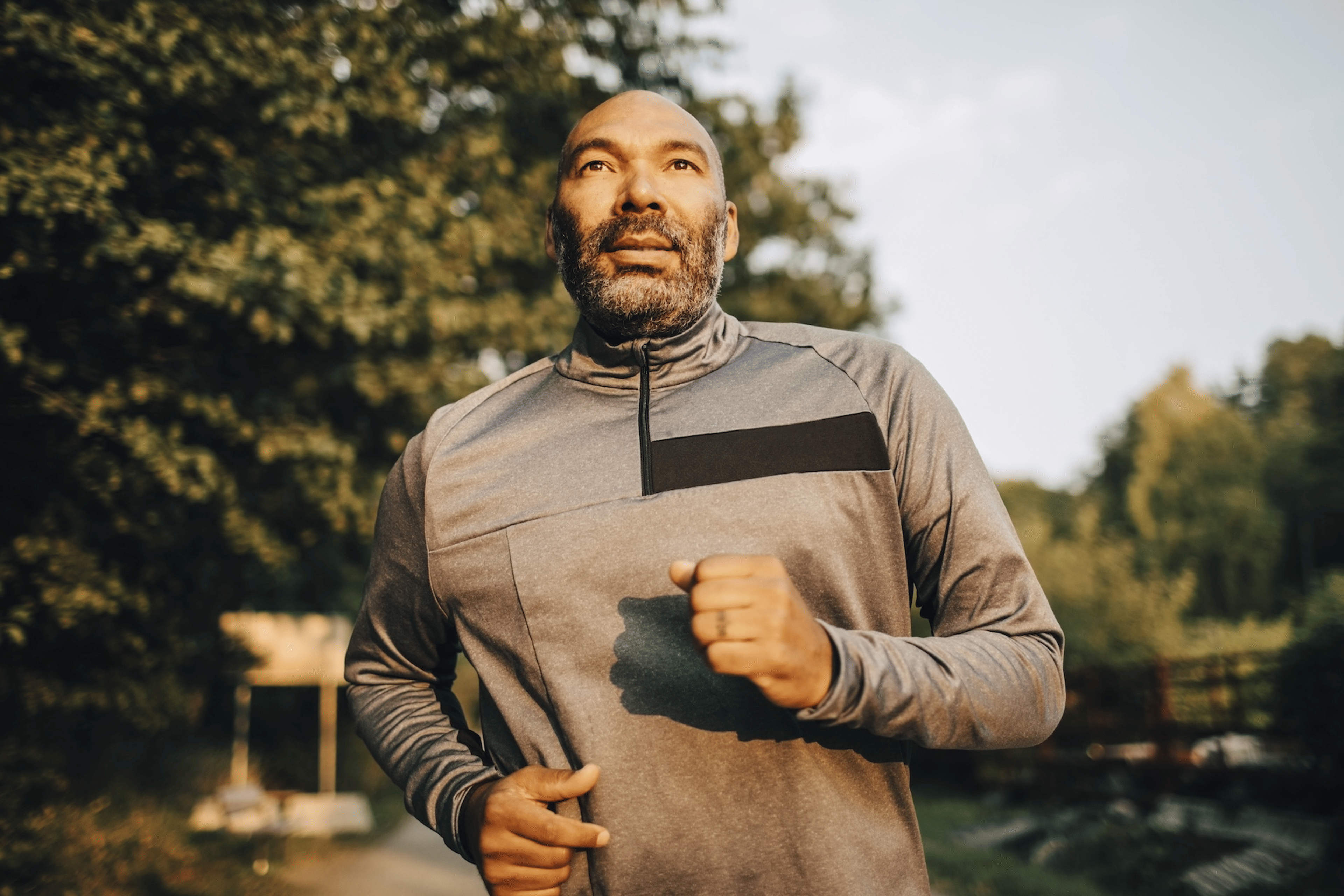 A middle-aged man going for a run outside in the morning.