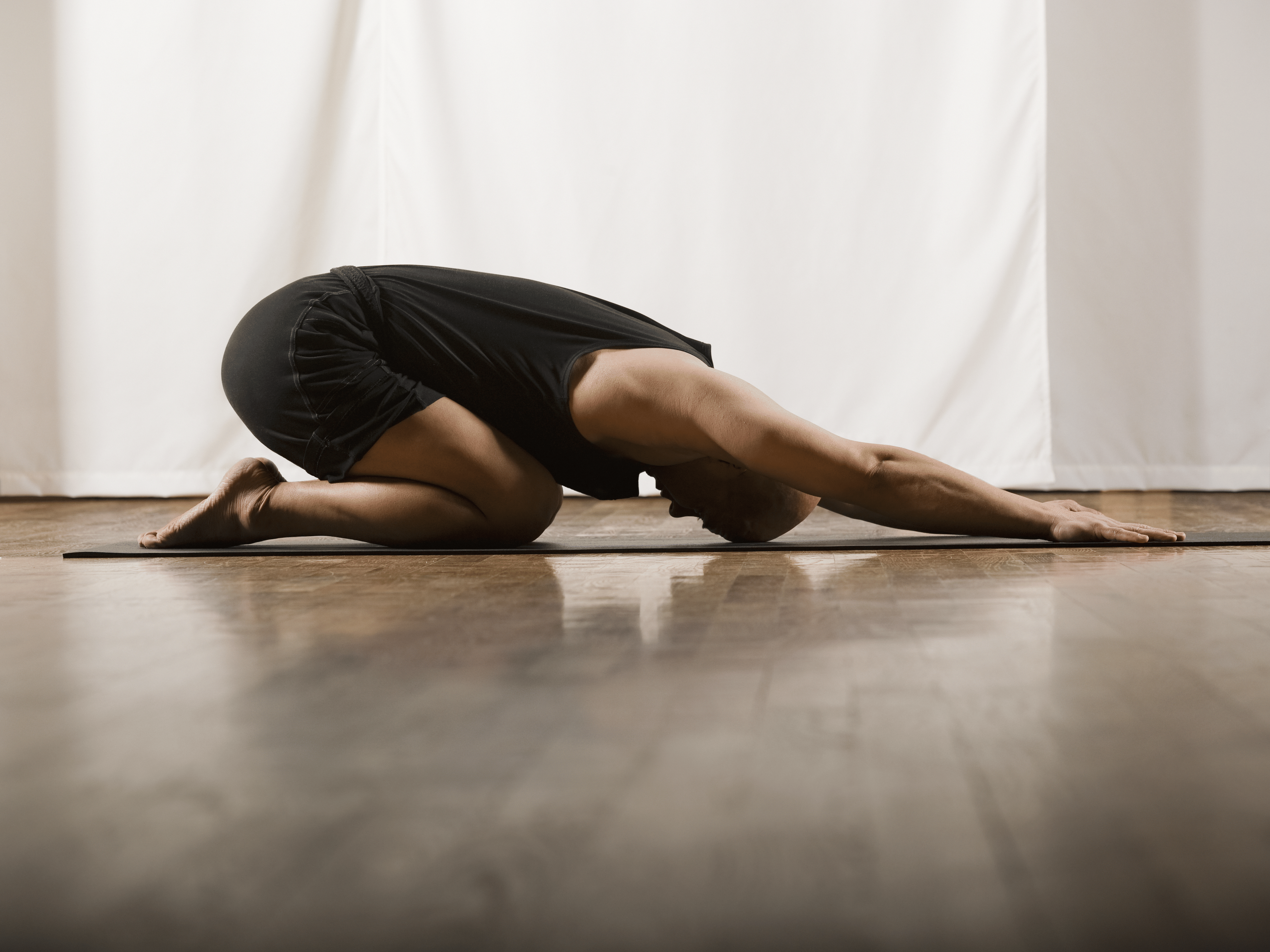 Man on ground in childs pose - yoga