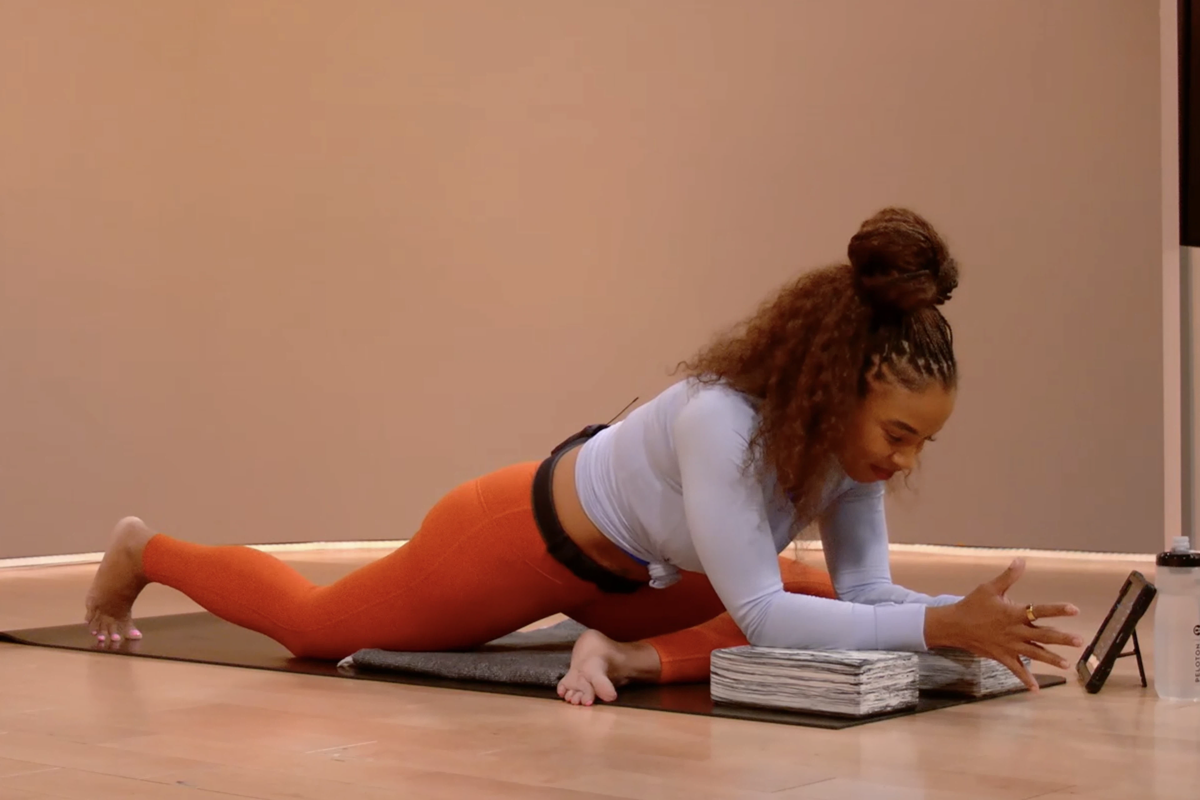 Woman does Pigeon Pose to stretch her glutes